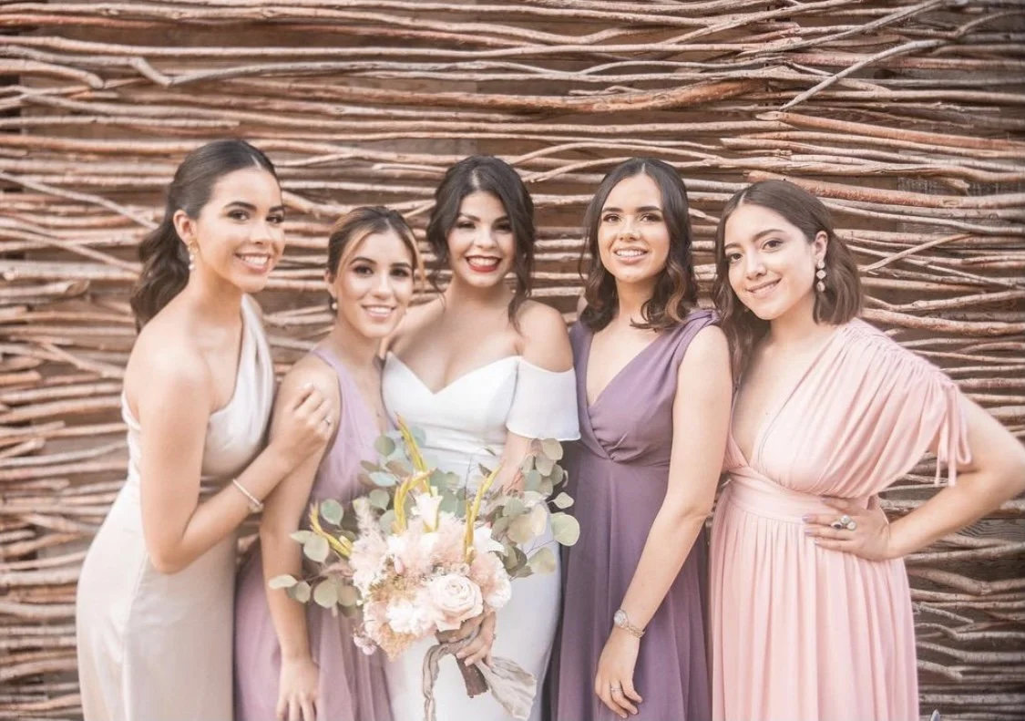 Bride and bridal party with professional hair and makeup, styled in a cohesive, natural glam look, looking confident, radiant, and wedding-day ready