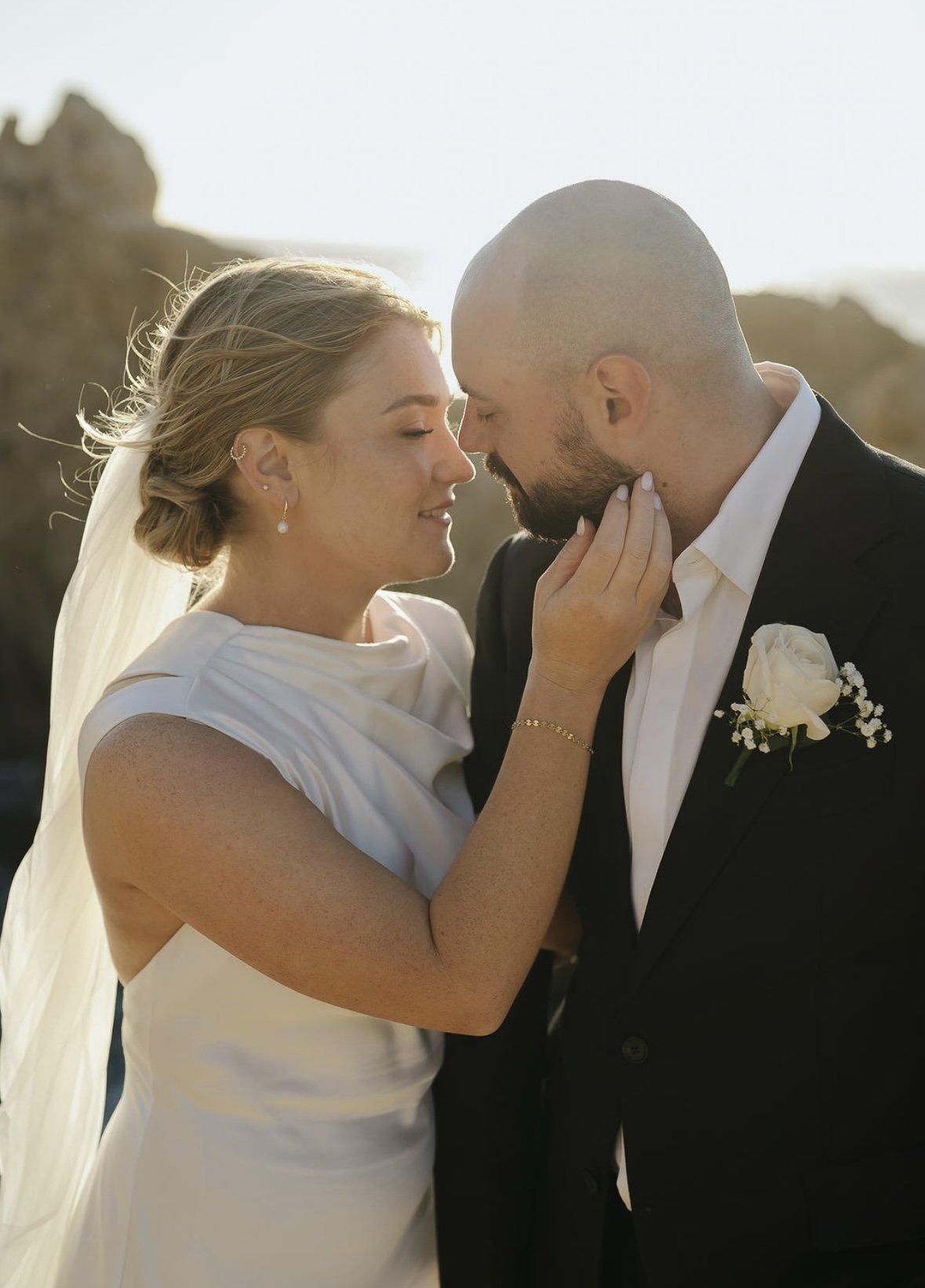 Bride with flawless, natural glam makeup sharing an intimate moment with her partner, radiating confidence, elegance, and timeless beauty