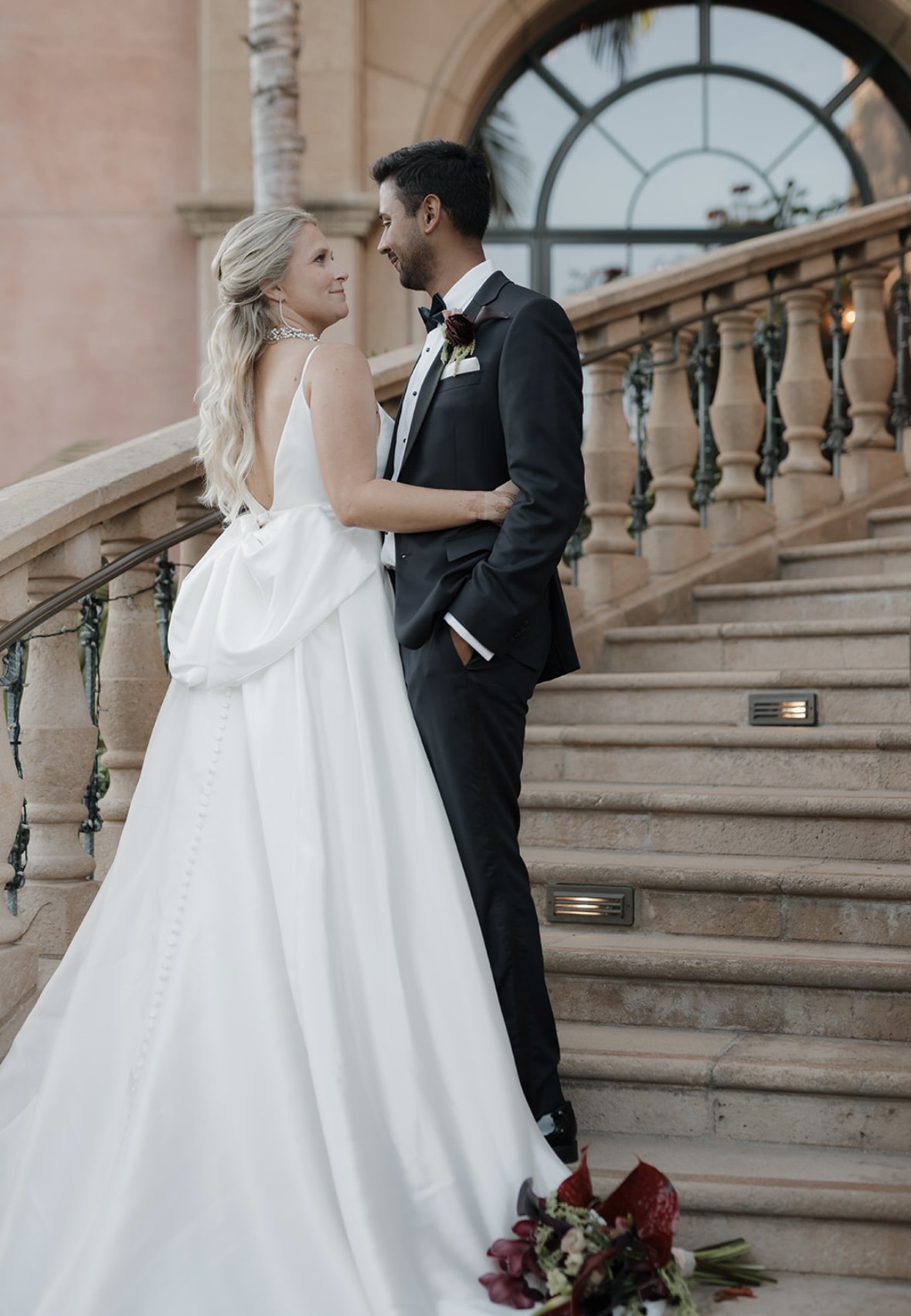 Bride with soft, timeless bridal glam sharing an intimate moment with her partner in a romantic, editorial-style wedding setting