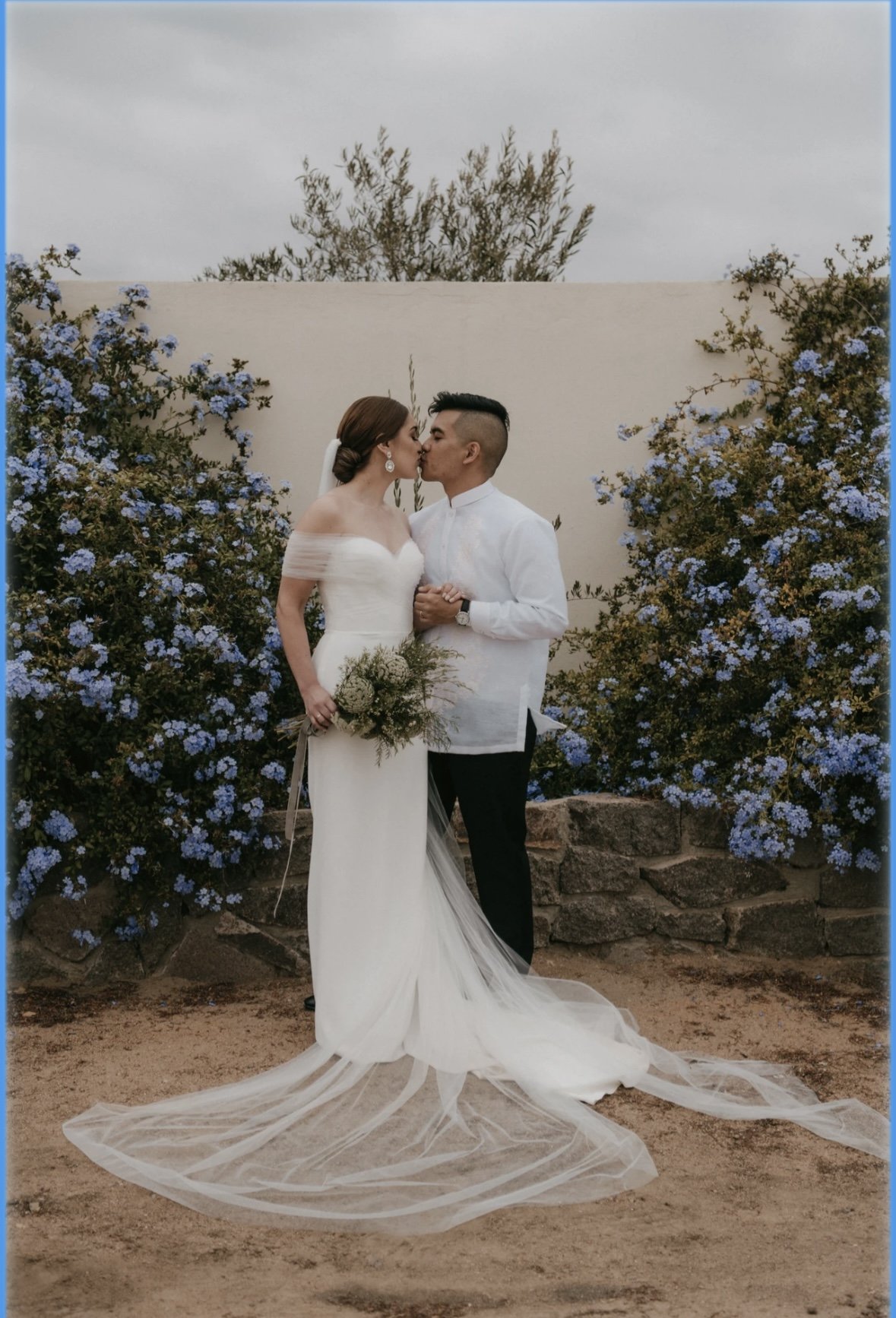 Bride with glowing, long-lasting wedding makeup sharing a romantic ceremony moment with her partner, looking confident and effortlessly beautiful