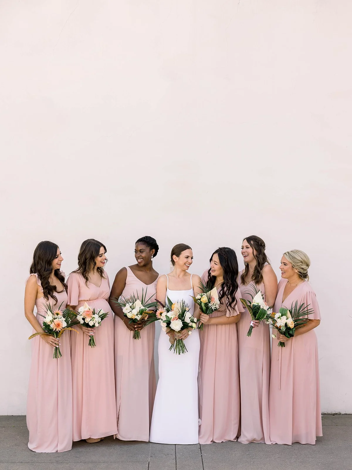 Bride and bridal party with cohesive hair and makeup looks celebrating together before the ceremony