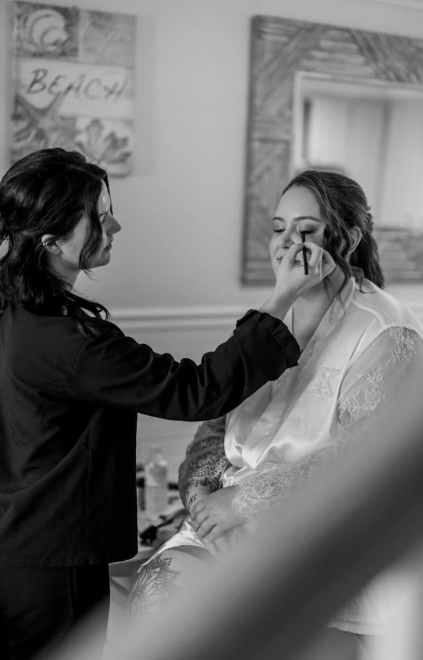 Bridal makeup application for a bride during wedding day preparation in a coastal California setting