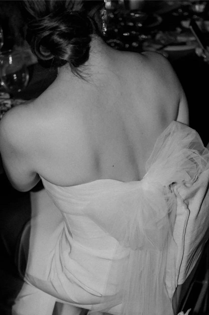 Bride with an elegant updo and timeless bridal styling captured in an editorial black-and-white moment, showcasing refined, elevated beauty.