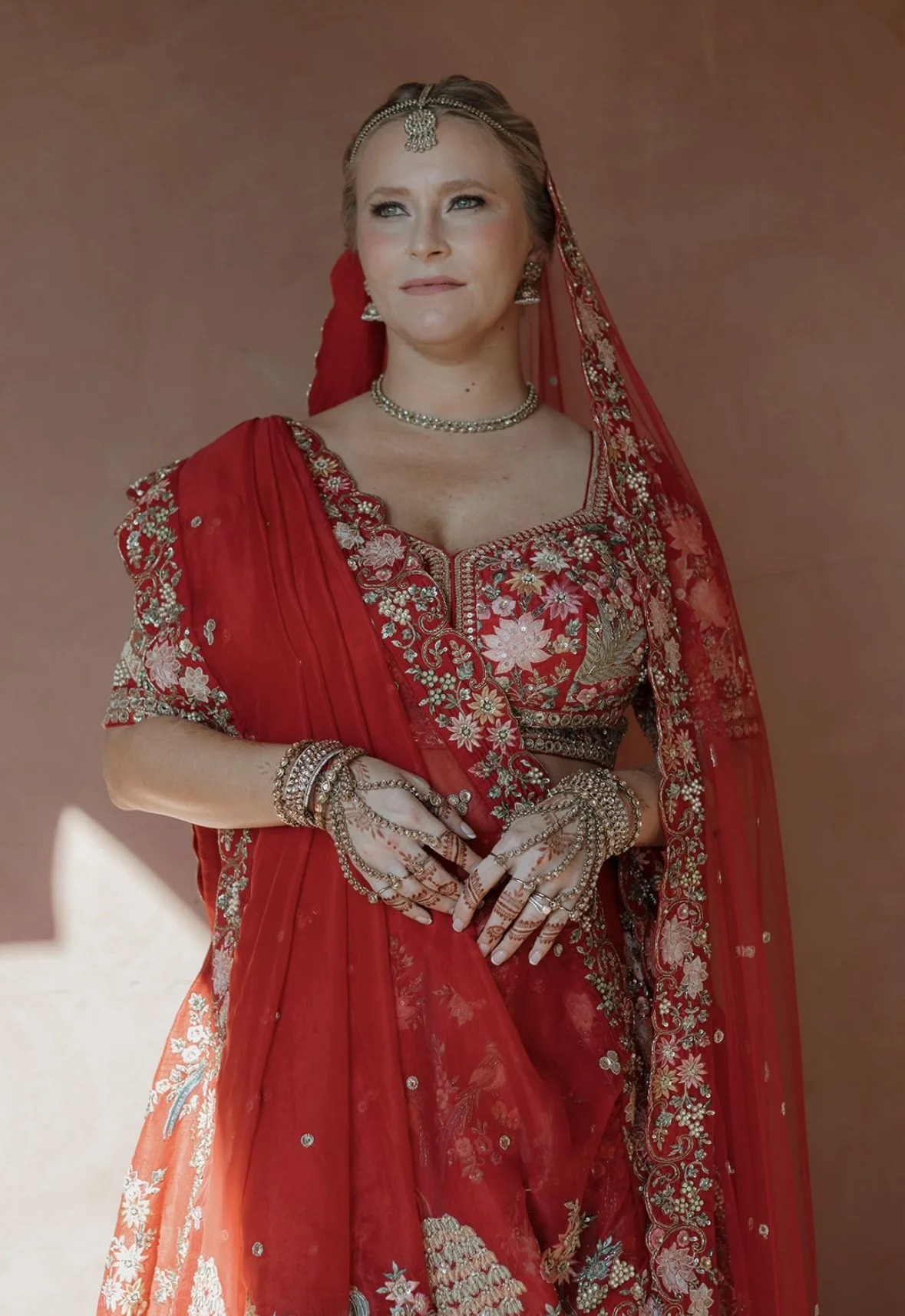 Bride in traditional Indian bridal attire with flawless, radiant makeup showcasing a timeless, culturally inspired wedding look