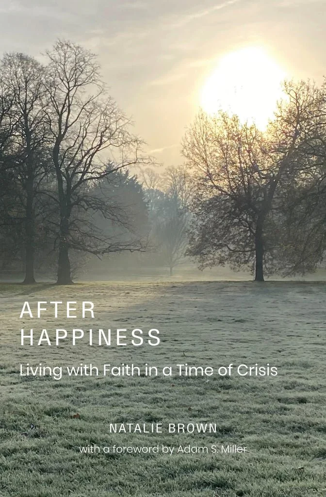 Cover of a book showing a foggy park with leafless trees, a grassy field, and the sun shining through the sky. The title reads 'After Happiness: Living with Faith in a Time of Crisis' by Natalie Brown, with a foreword by Adam S. Miller.