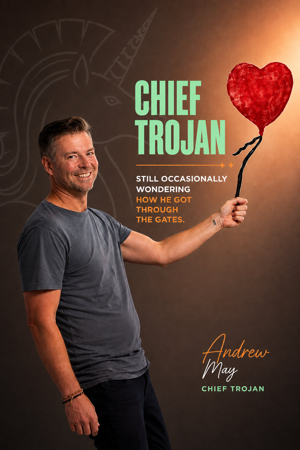 A man smiling and holding a heart-shaped balloon on a stick, with promotional text for a book titled "Chief Trojan" by Andrew May.