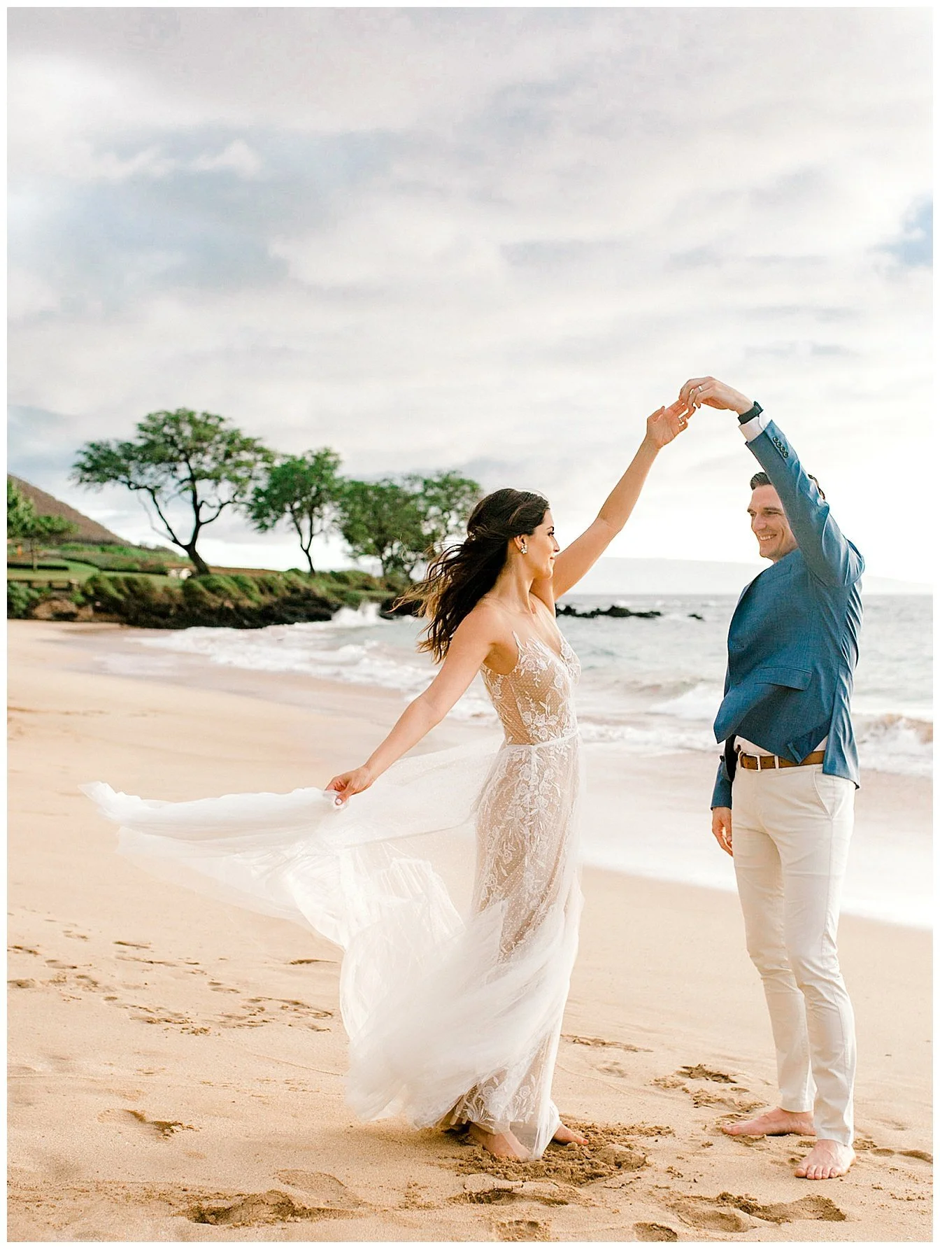 Bride and groom dancing on a Maui beach