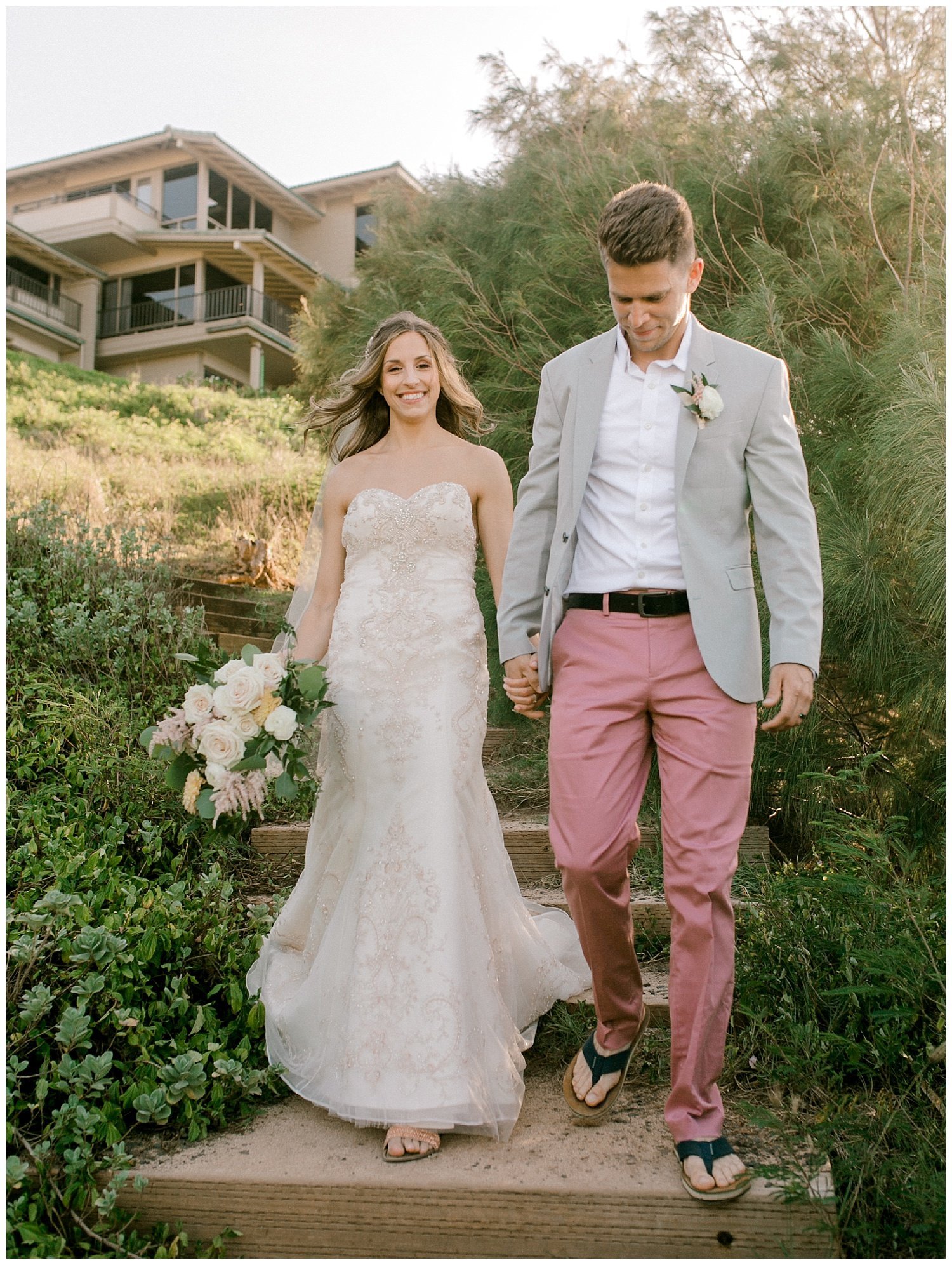 Bride and Groom walking down steps to Maui beach