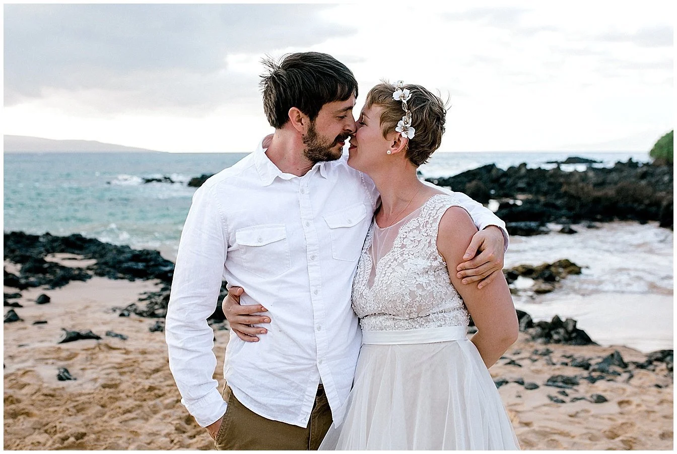 Bride and groom embracing on Maui beach