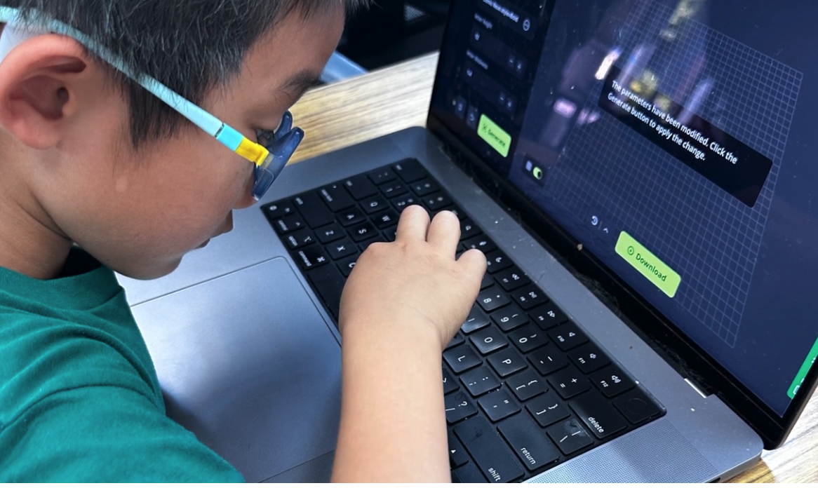 A young boy with glasses is focused on a laptop, interacting with a screen that displays a grid and options for modification. The boy is sitting at a wooden desk.