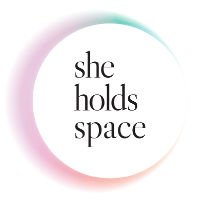 Text reading "she holds space" with a circular, rainbow-colored border.