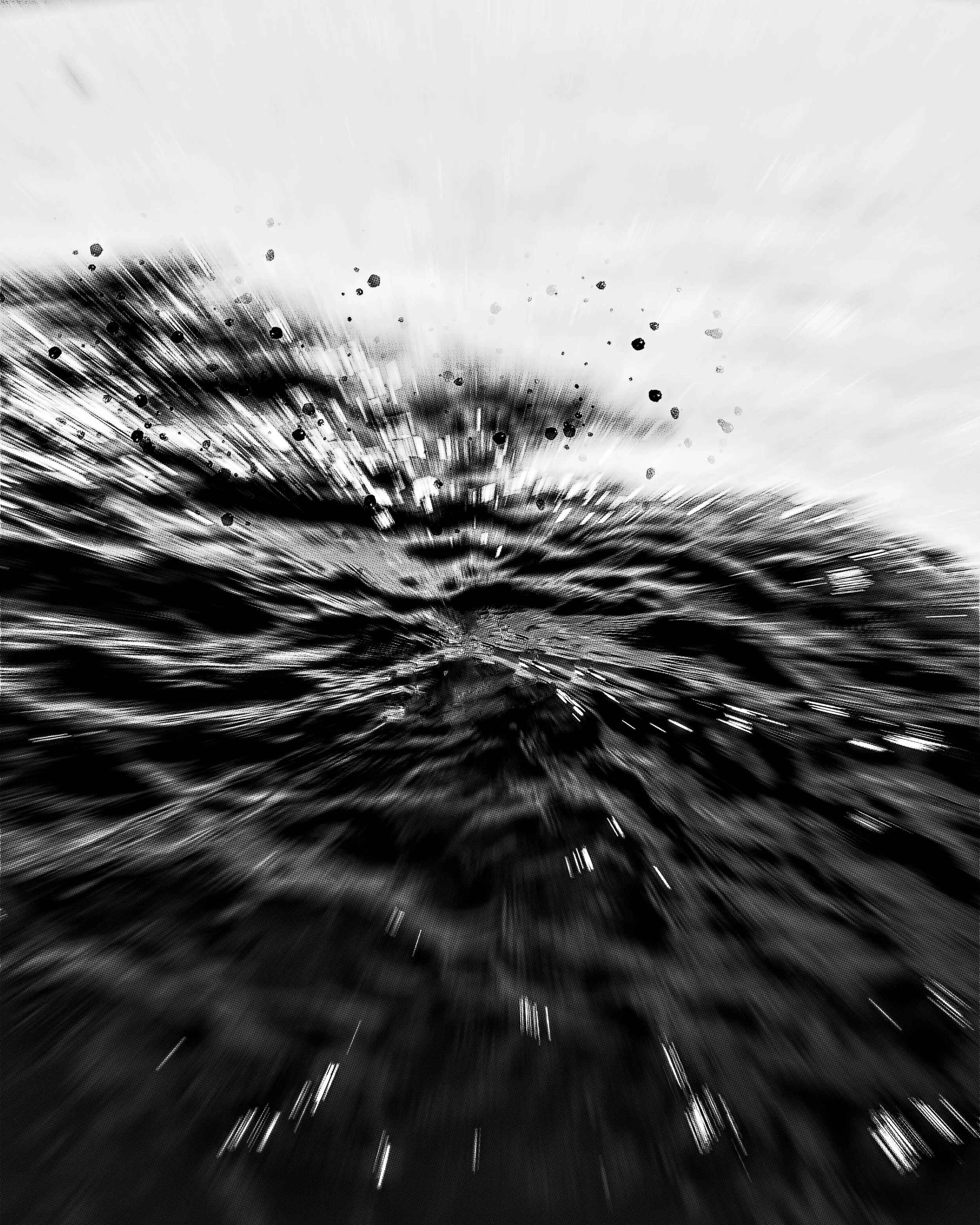 Foto em preto e branco de uma explosão de tinta na água, com efeito de movimento.