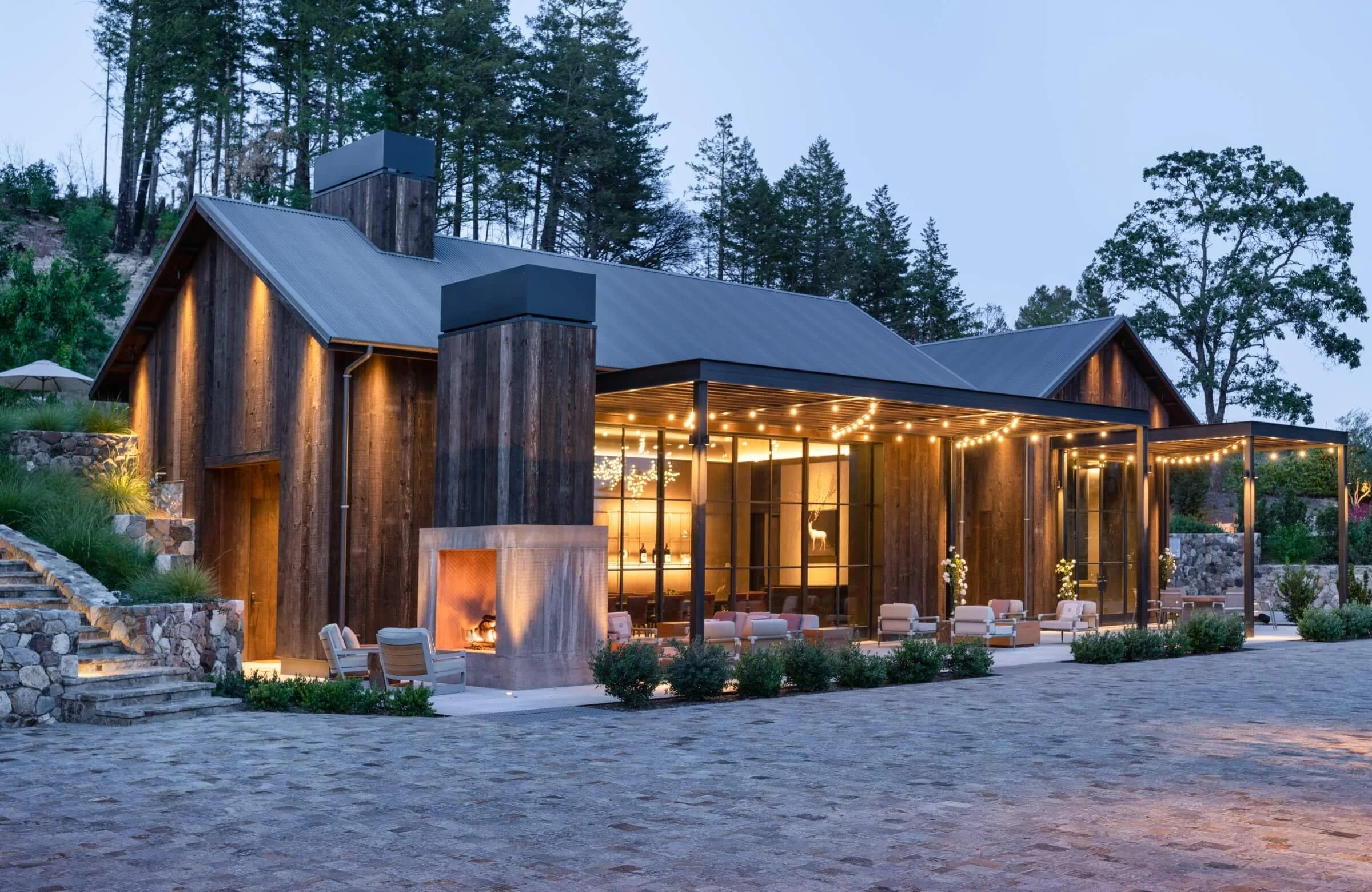 Elevated view of Mayacamas Vineyards' upper terrace, showcasing the comprehensive architectural lighting plan for the Mount Veeder hospitality center and vineyard views.