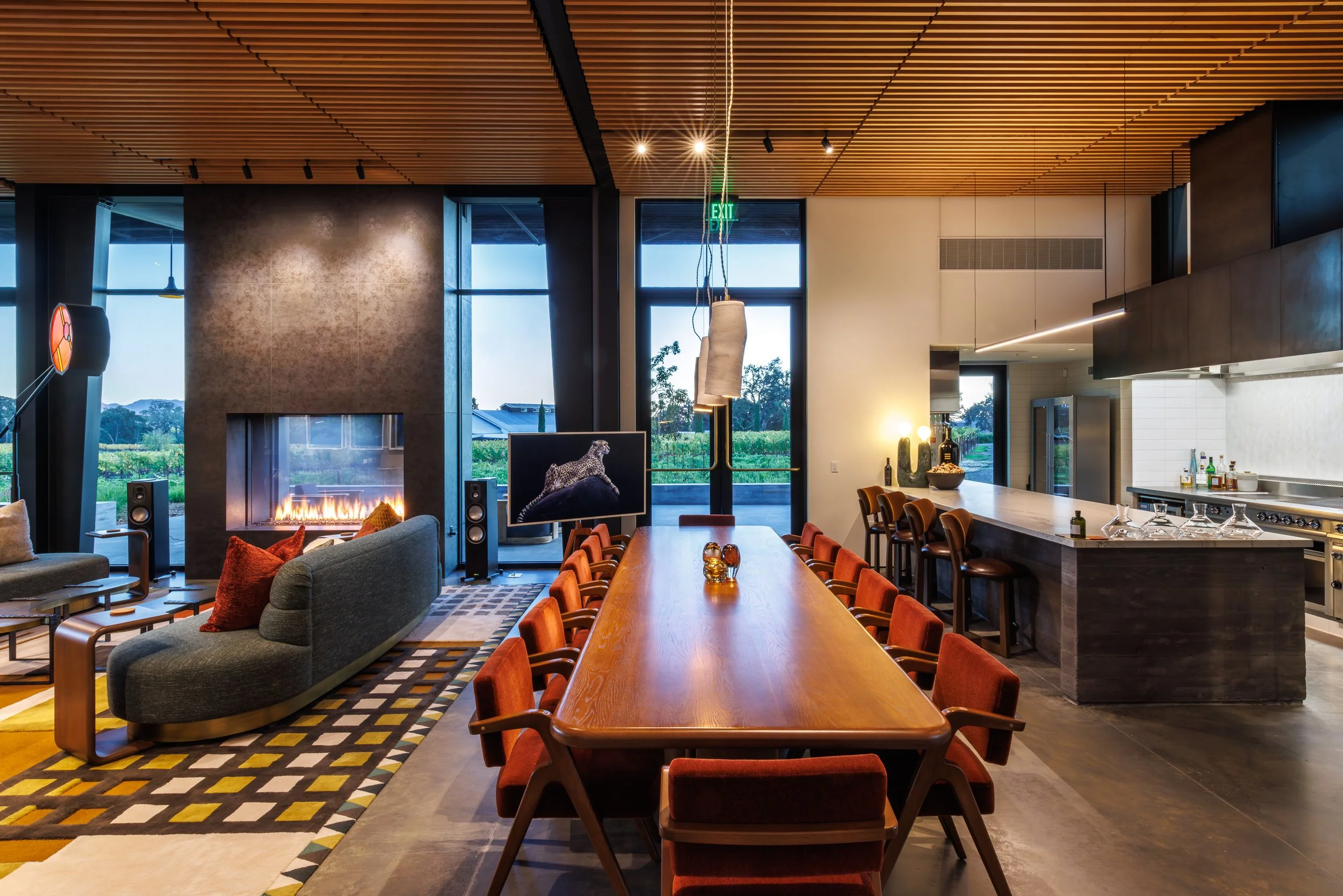 A combination of natural light and architectural lighting defines the tasting room, creating a comfortable connection between the interior and surrounding landscape.