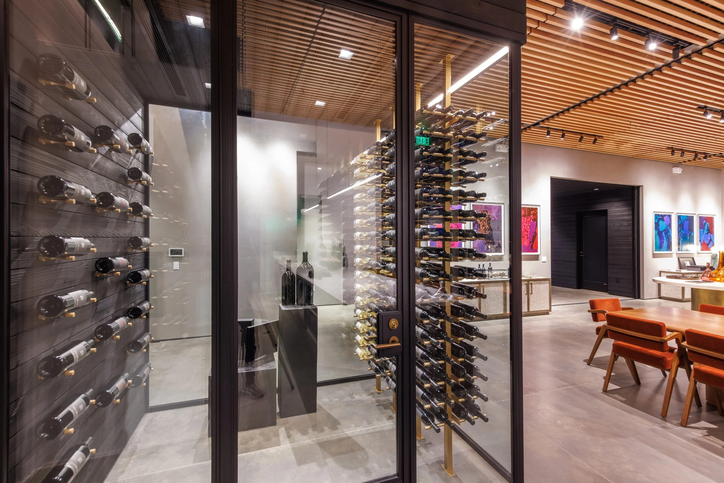 Carefully integrated lighting showcases the wine collection while complementing the refined materials and modern design of the interior.