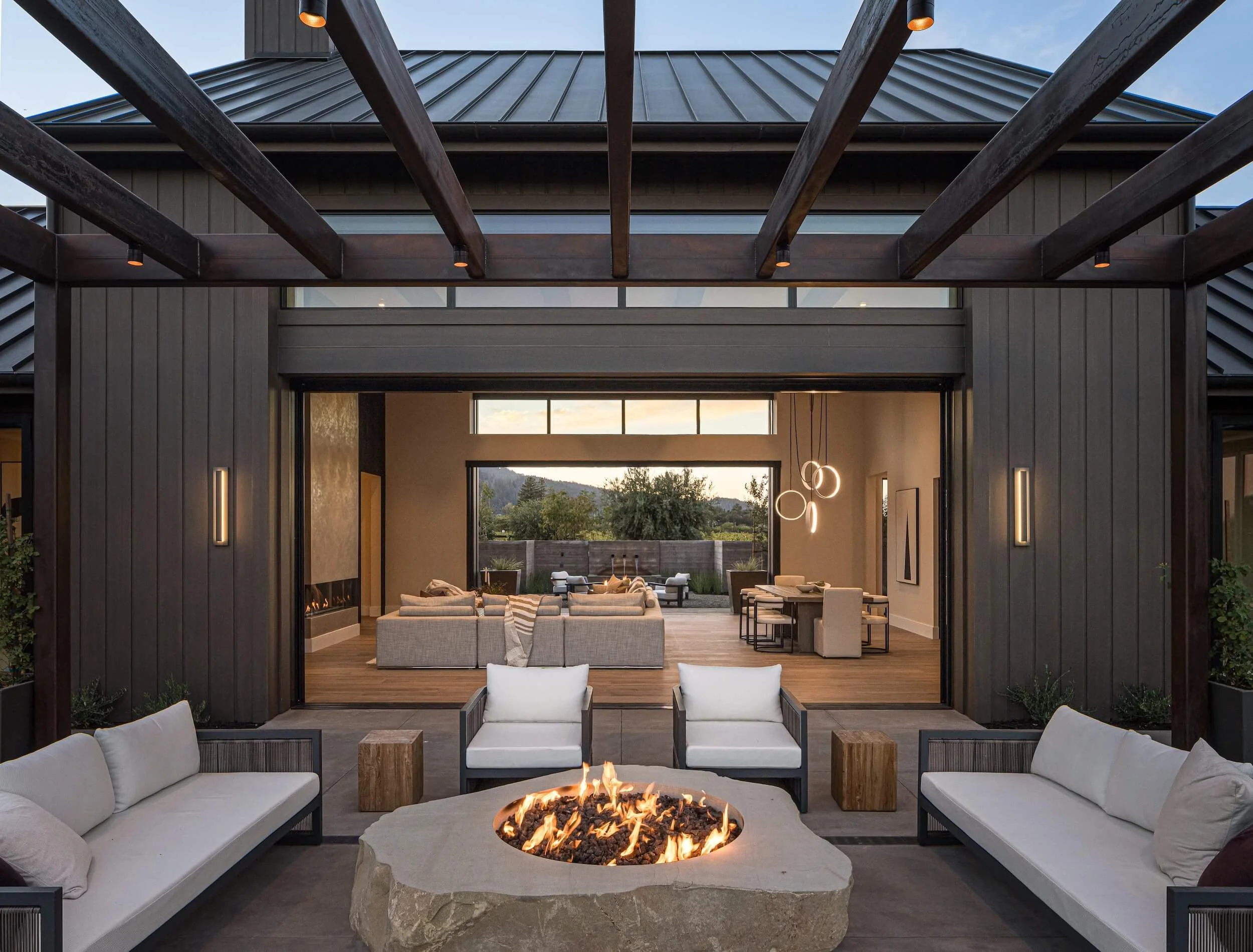 Modern outdoor living space featuring recessed ceiling heaters and architectural cove lighting at a St. Helena estate.