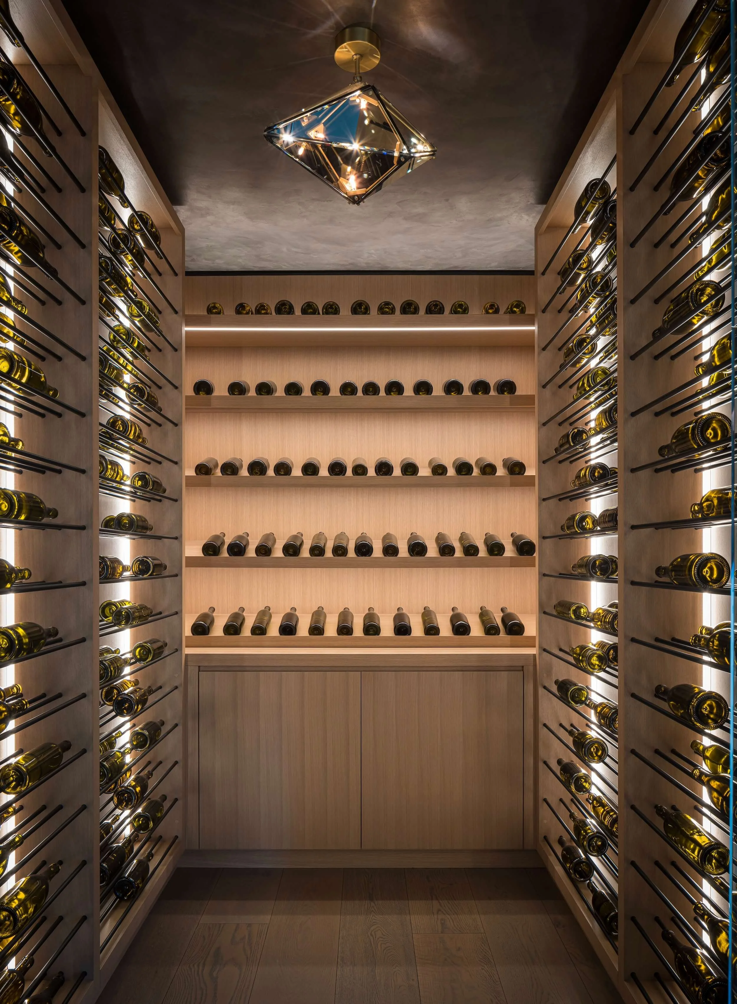 Custom LED wine cellar lighting design in Napa, featuring vertical backlighting for a temperature-controlled glass display in a premium residential project
