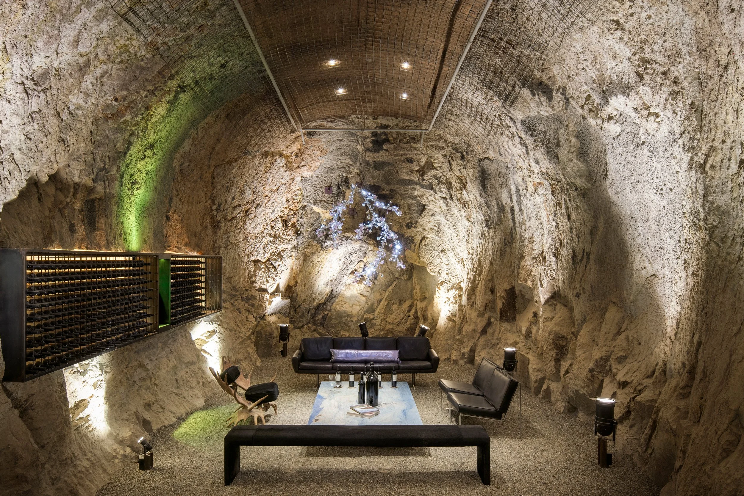 Integrated lighting brings warmth and focus to the natural stone architecture of the Hourglass Winery cave while preserving its intimate atmosphere.