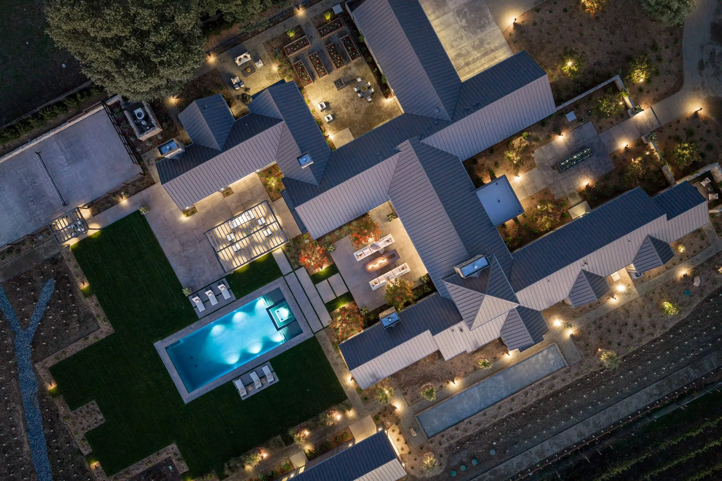 Aerial view of a luxury Napa Valley compound, showcasing full-scale residential electrical integration across a two-acre estate with synchronized exterior lighting and pool-to-house transitions.