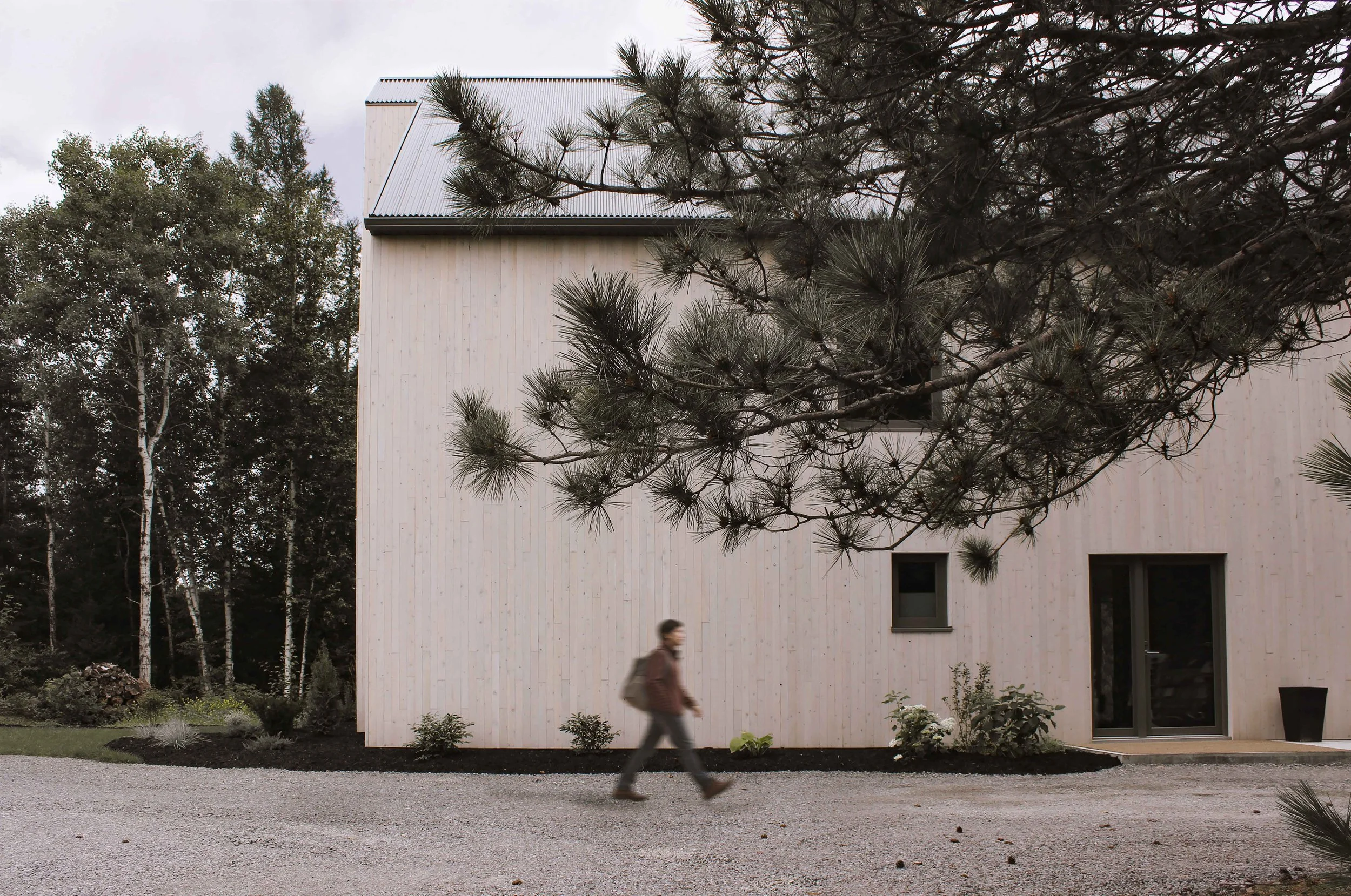 Custom single-family home in Northern Ontario with pitched roof and natural wood exterior.