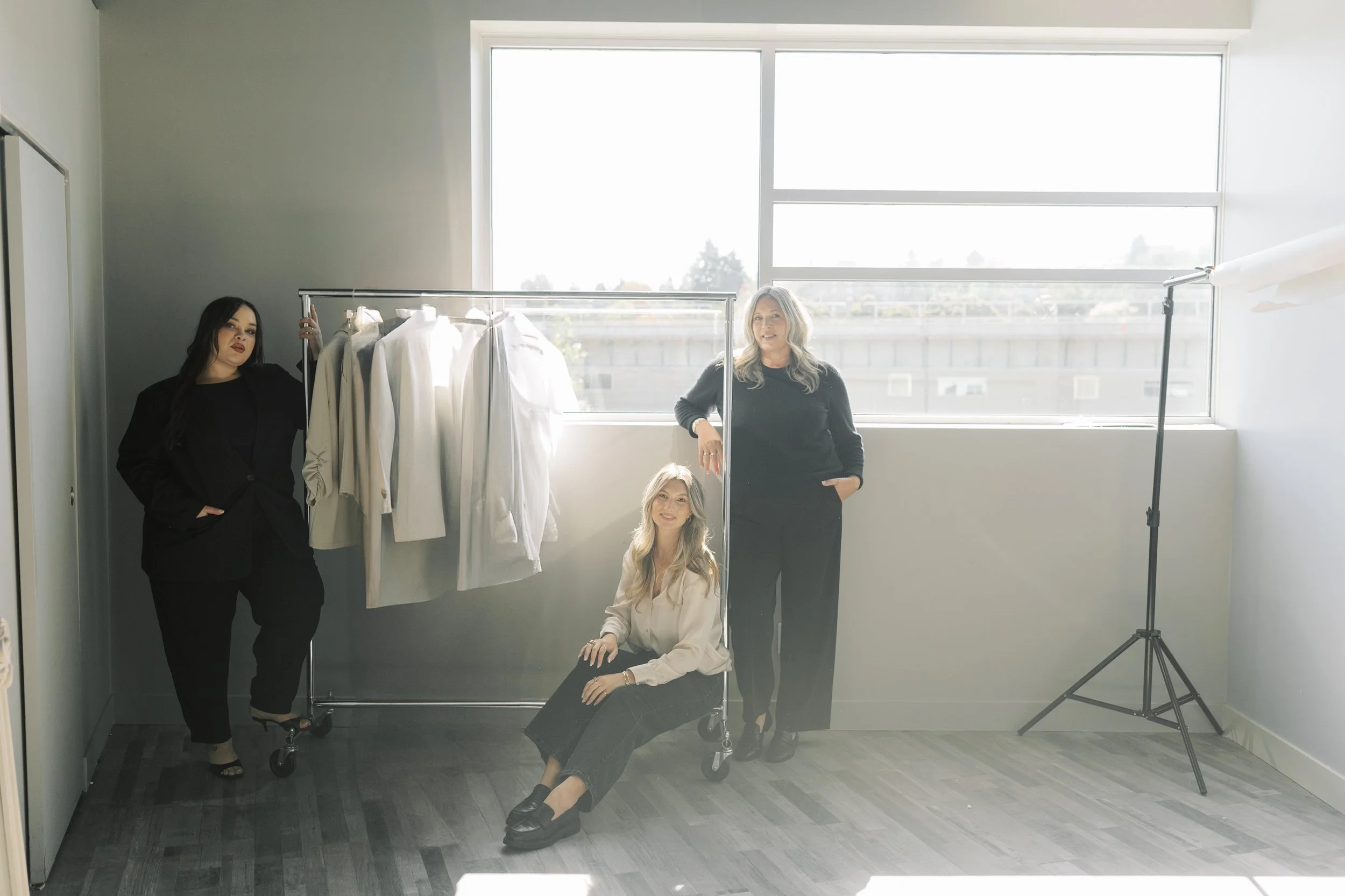 Susan Cooper Agency Team with a clothing rack of wholesale fashion for Western Canada