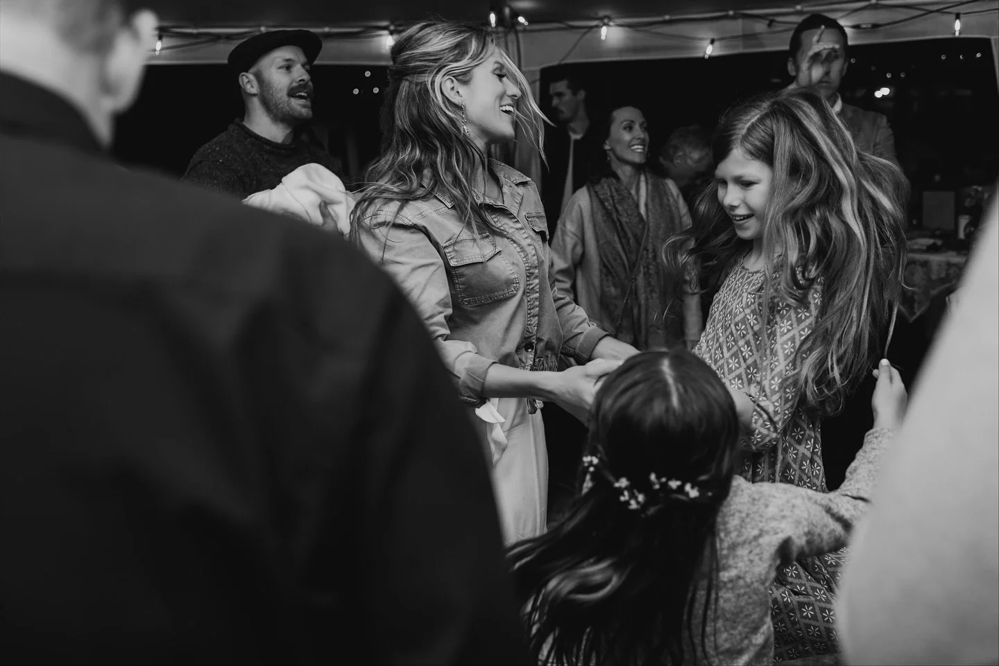 A dance floor photo dump of the alternative option - instead of a fancy venue, you send out a group text asking for event tents. You hoist them up in your backyard while it slowly starts to rain. You order the pizza. You invite all your favorite frie