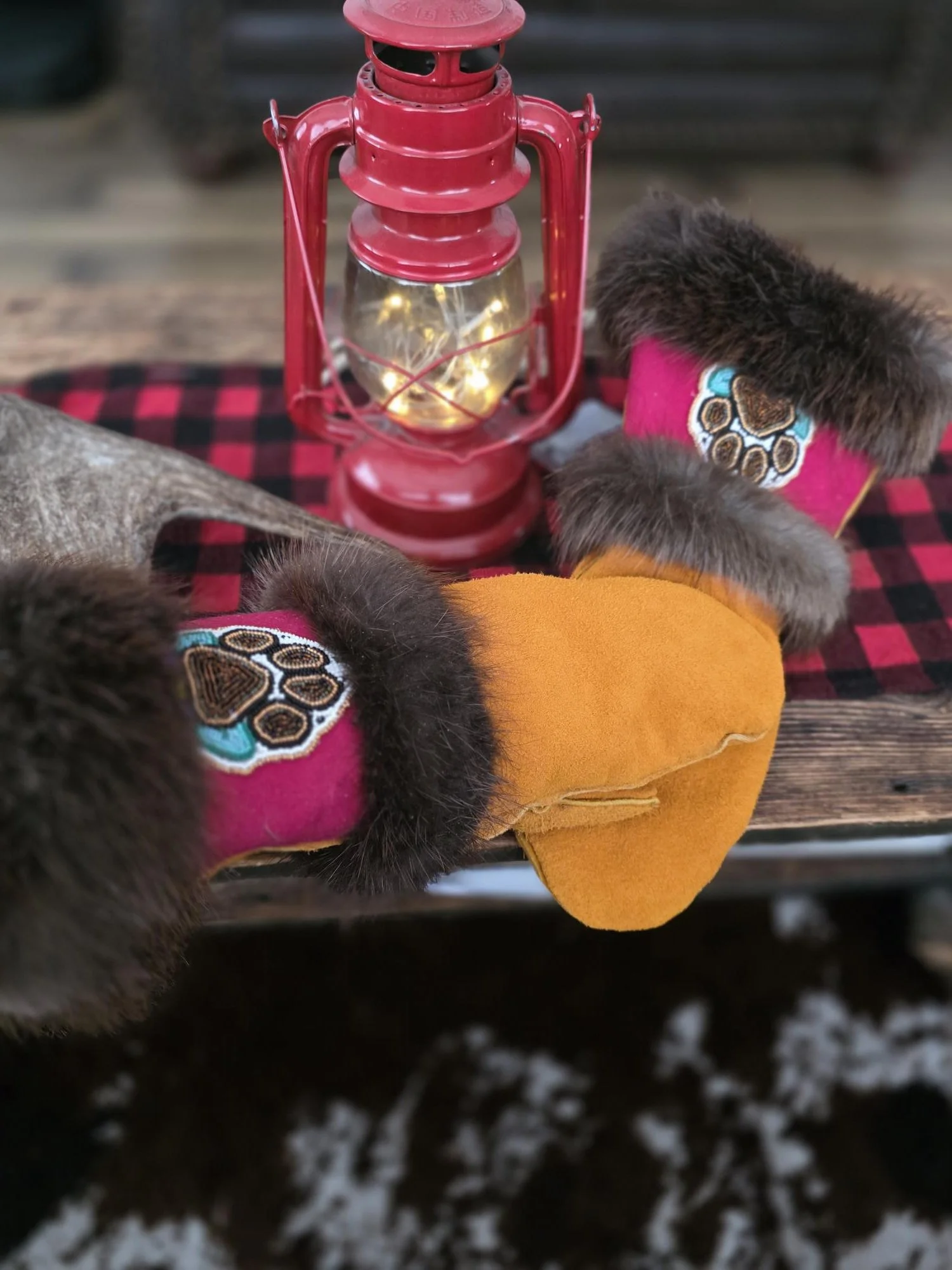 A pair of moose hide gauntlet mitts with beaver fur trim and wolf paw beadwork.