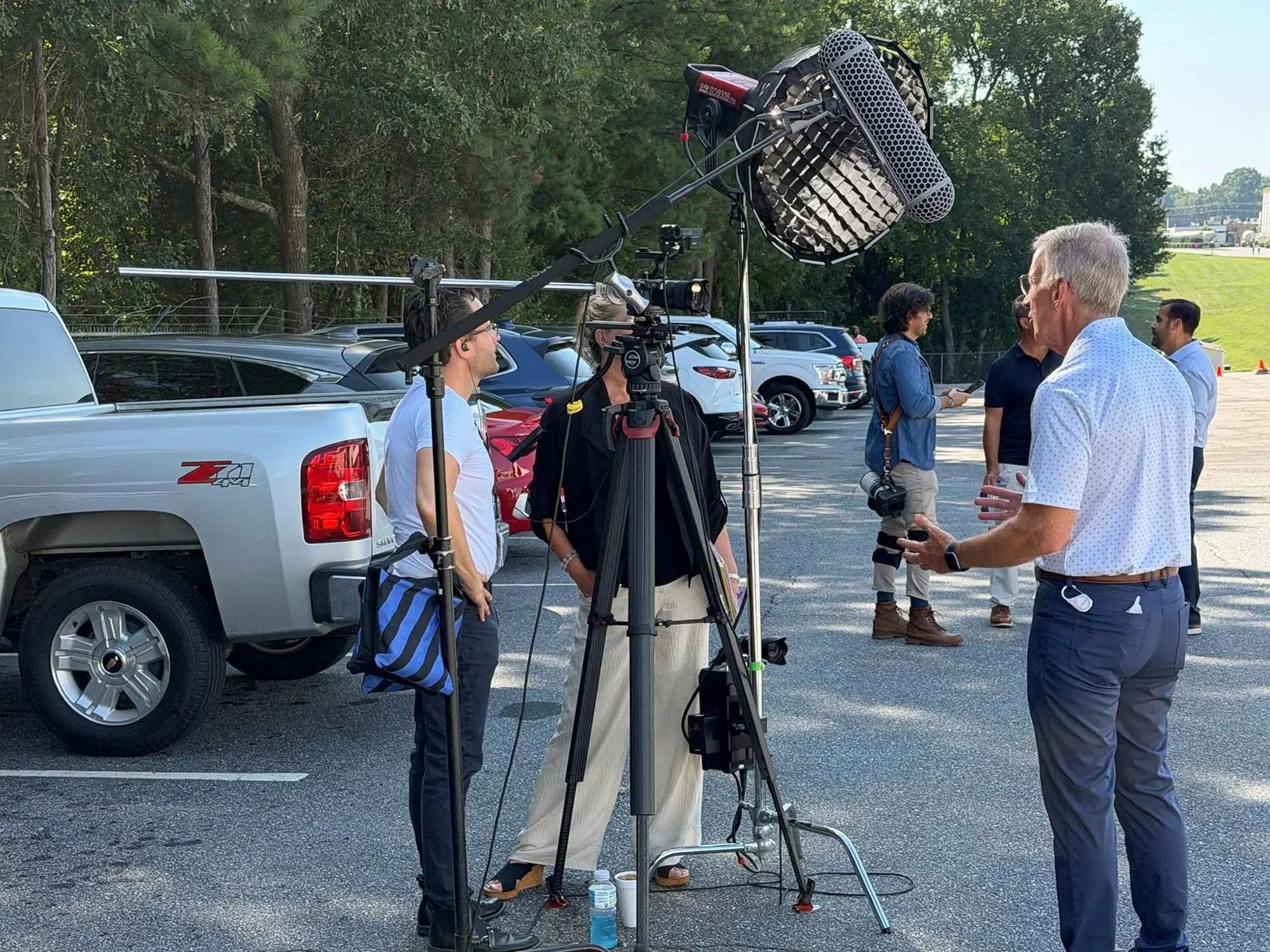 Corporate event video crew filming an outdoor interview during CommScope’s 50th anniversary celebration in Catawba, NC.