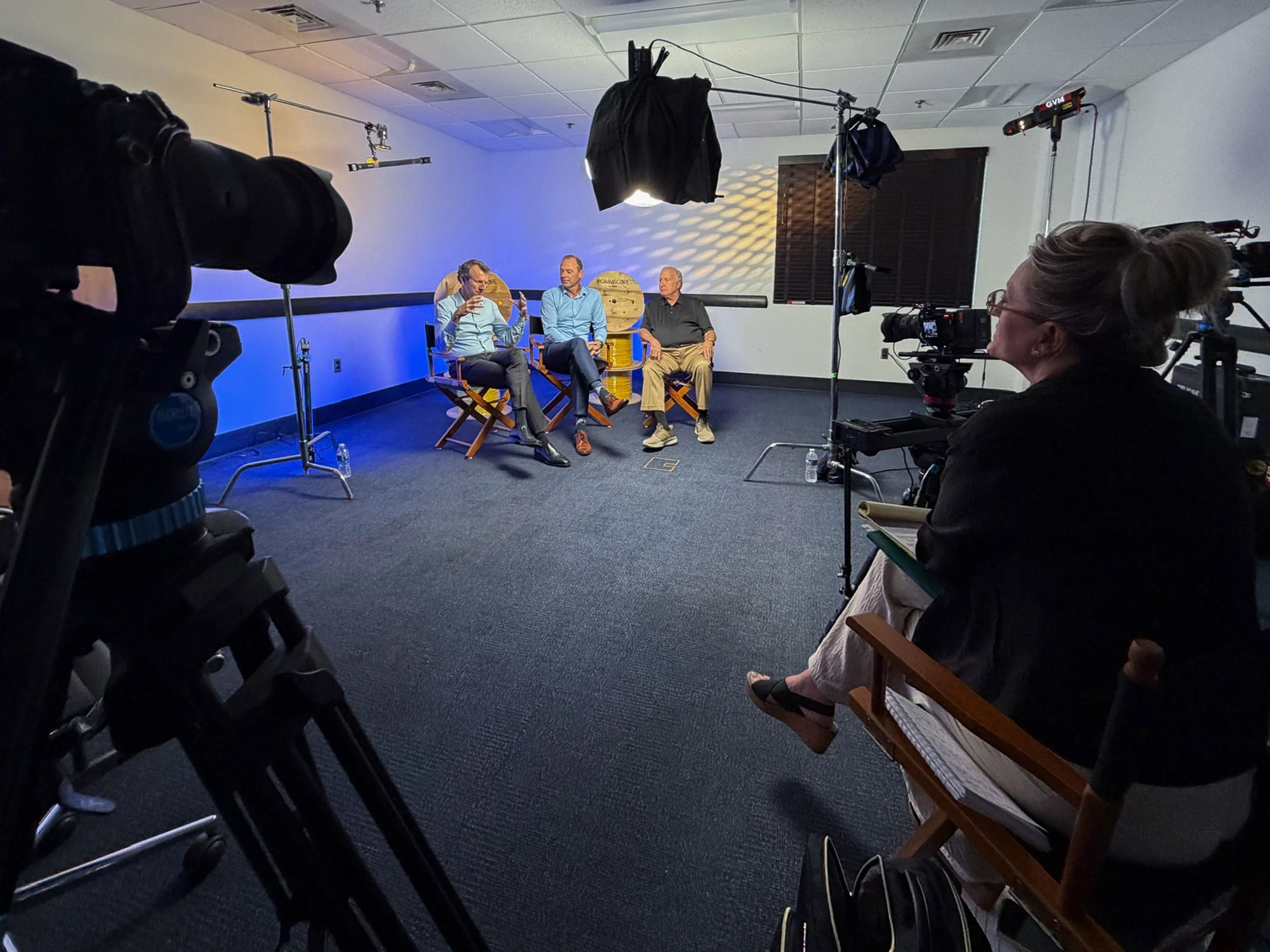 Corporate event video crew filming interviews outdoors during CommScope’s 50th anniversary celebration.