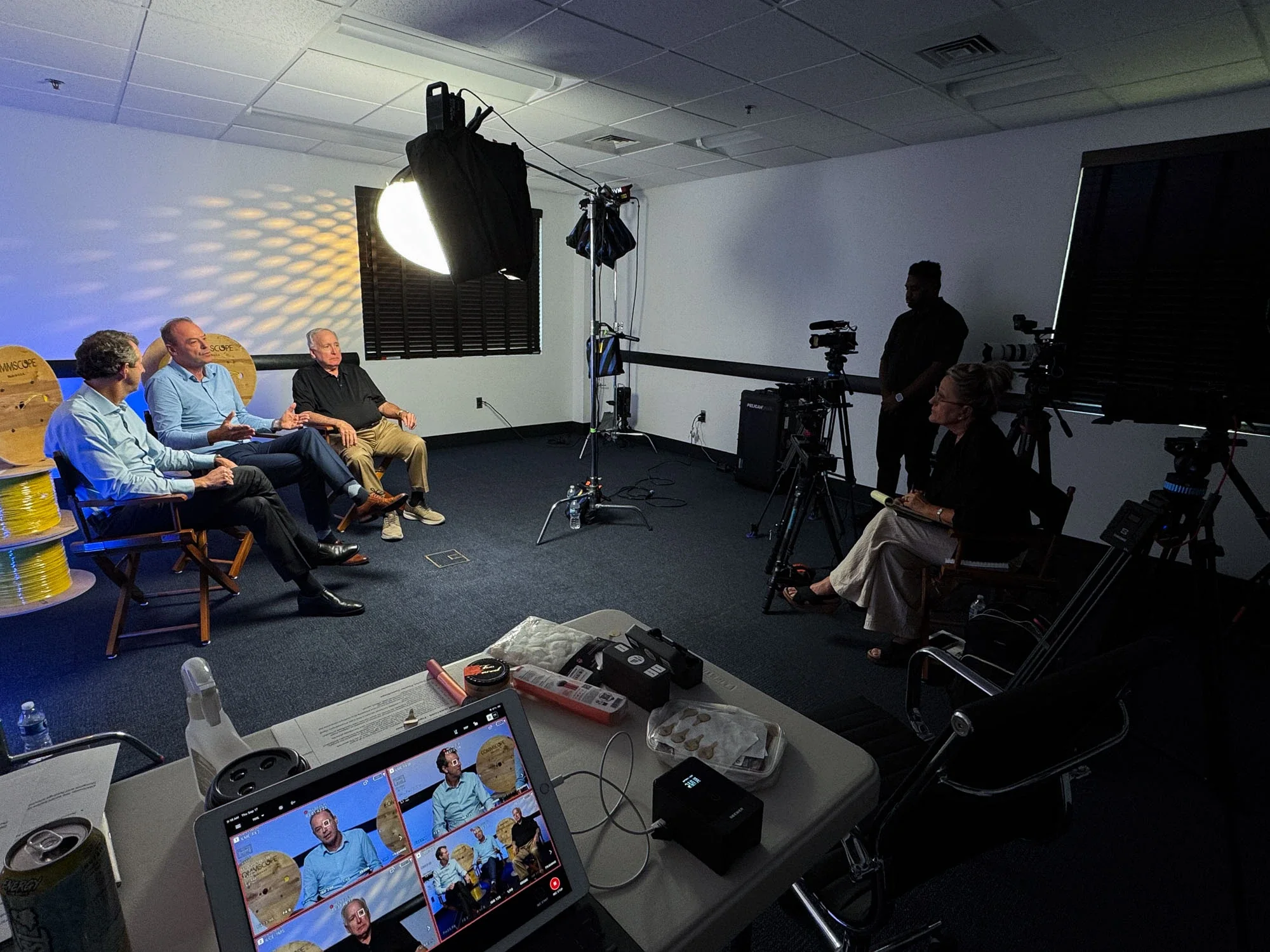 Trade Street Media filming a three-person interview with professional lighting and cameras at CommScope in Catawba, NC.