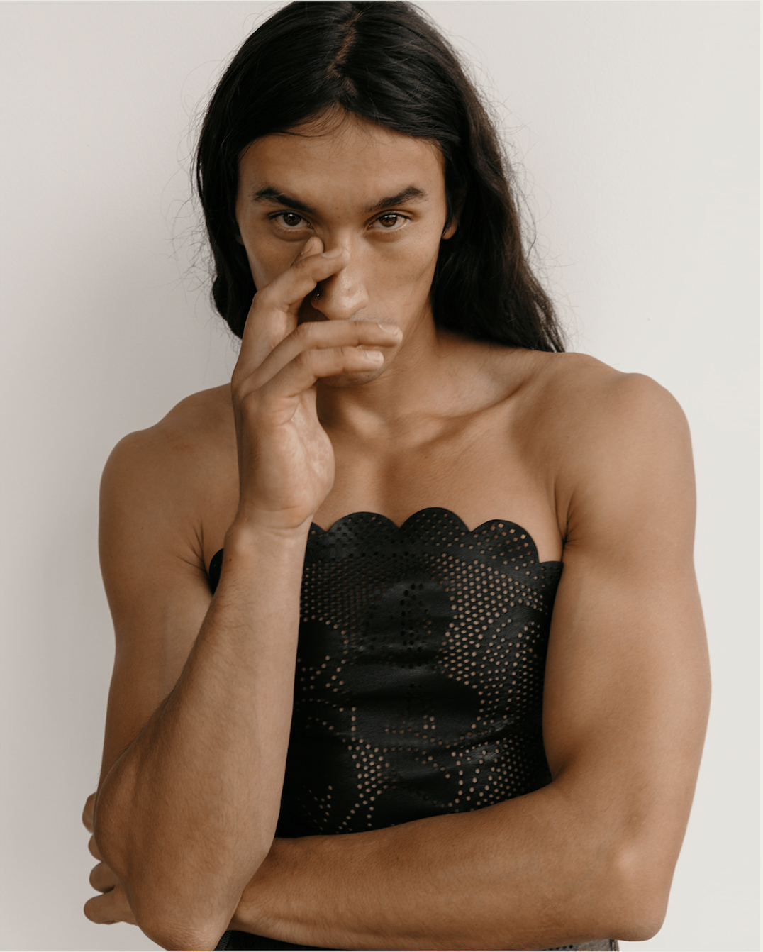 Image of a mexican male model on a white background wearing a black leather tube top