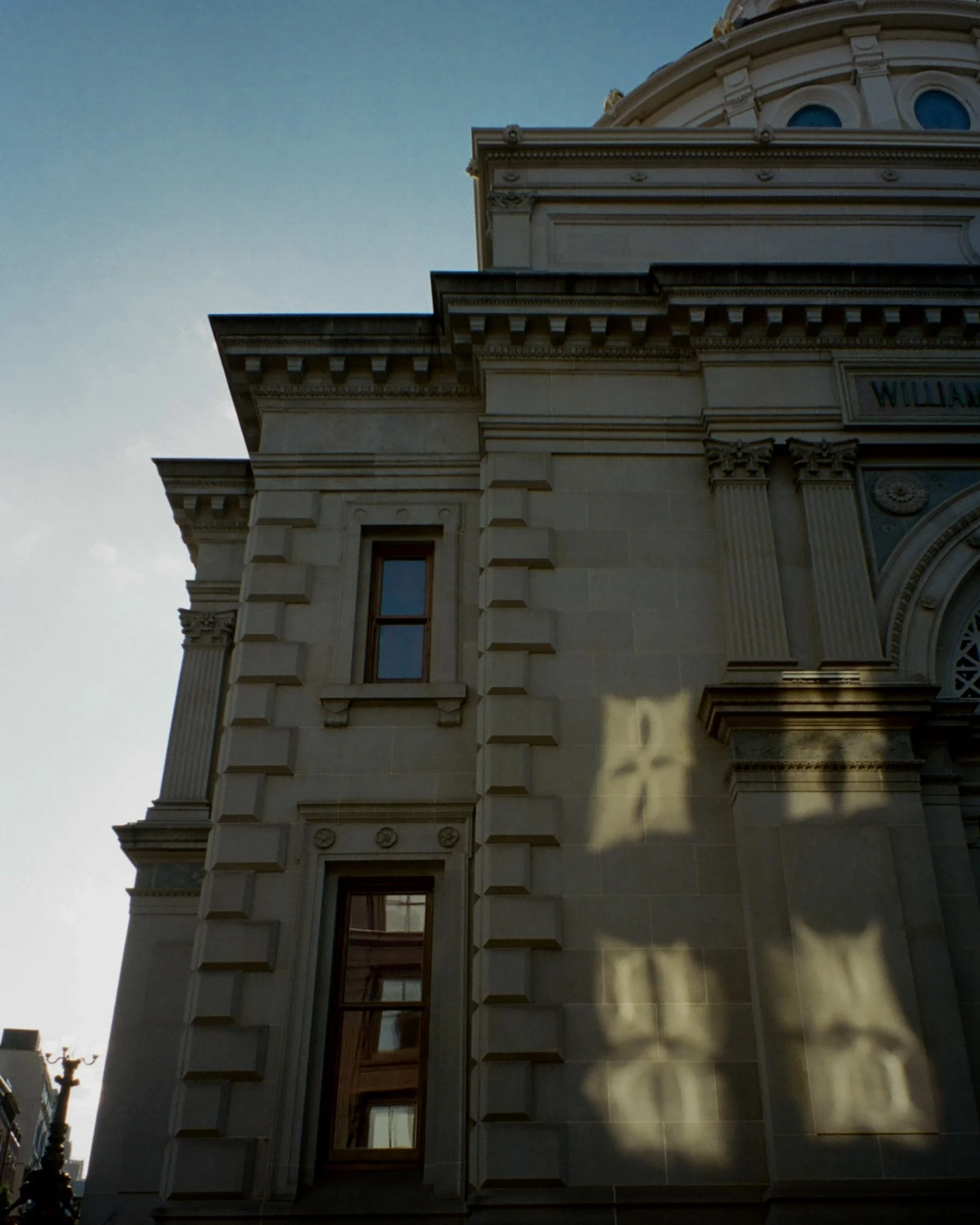 Photo of sunlight reflecting from windows of one building onto another