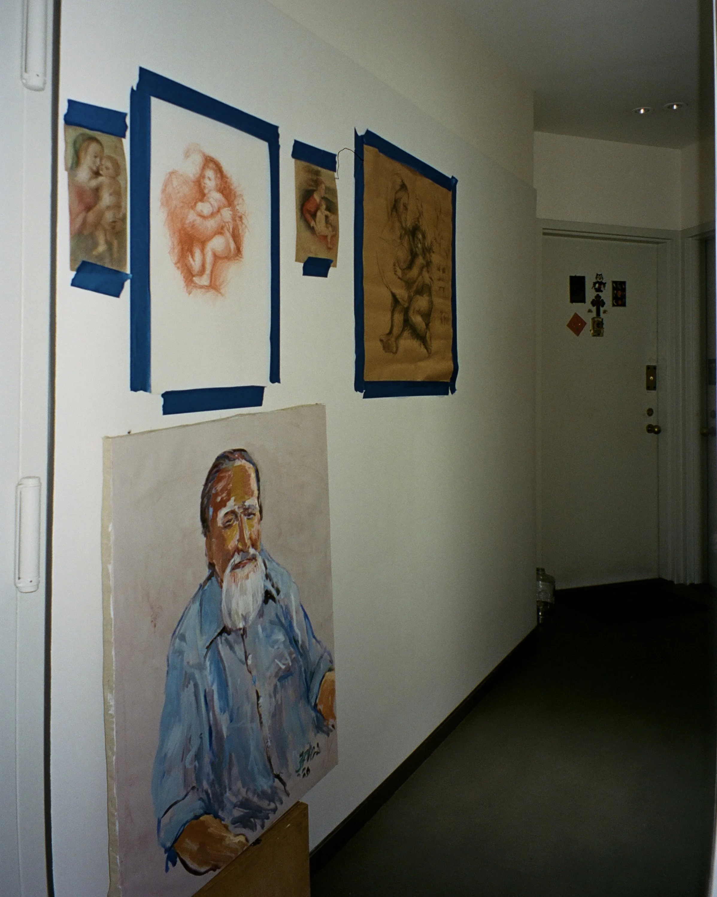 A photo of an illustration artist's work displayed in the hallway  of his apartment