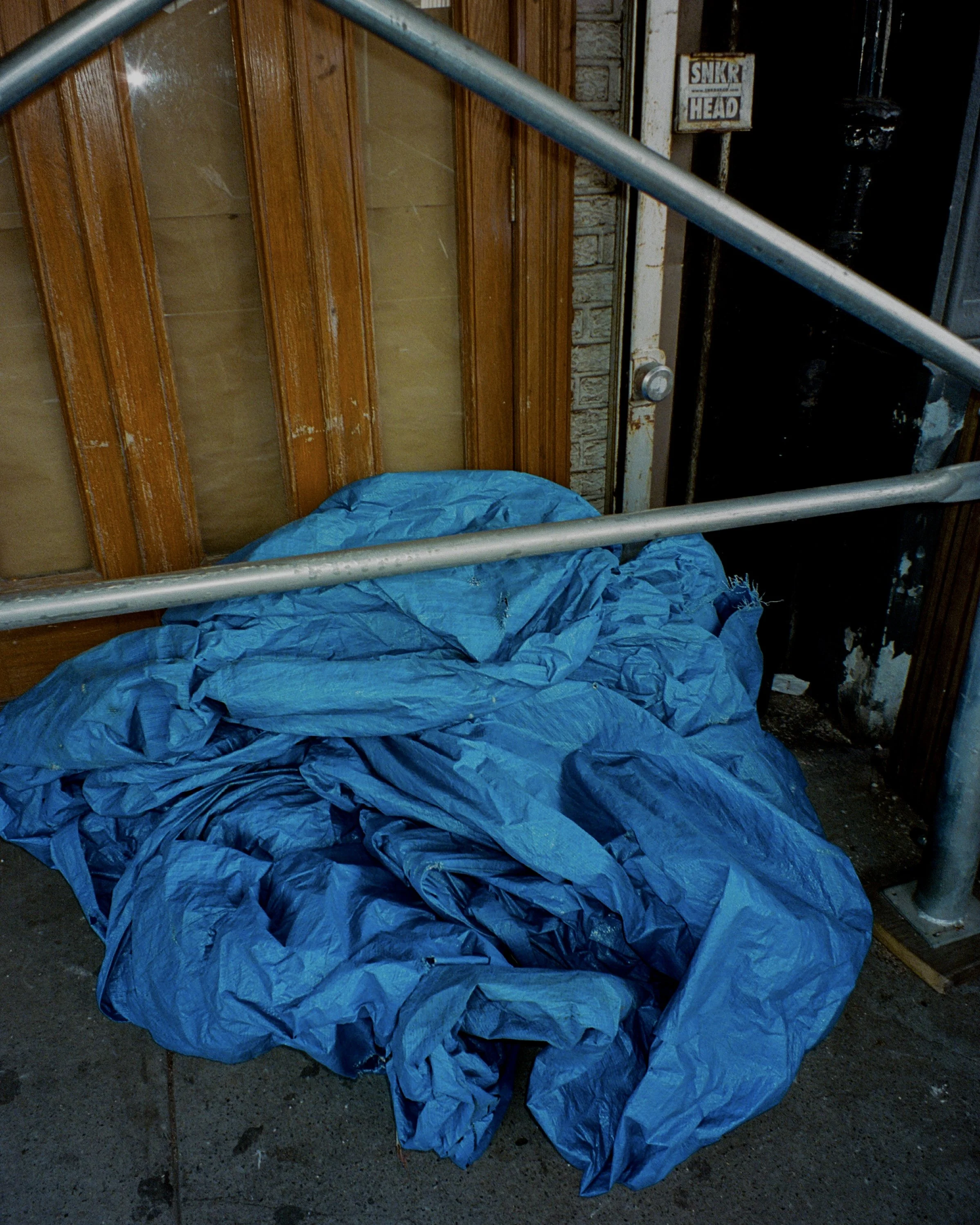 Blue tarp crumbled on the sidewalk