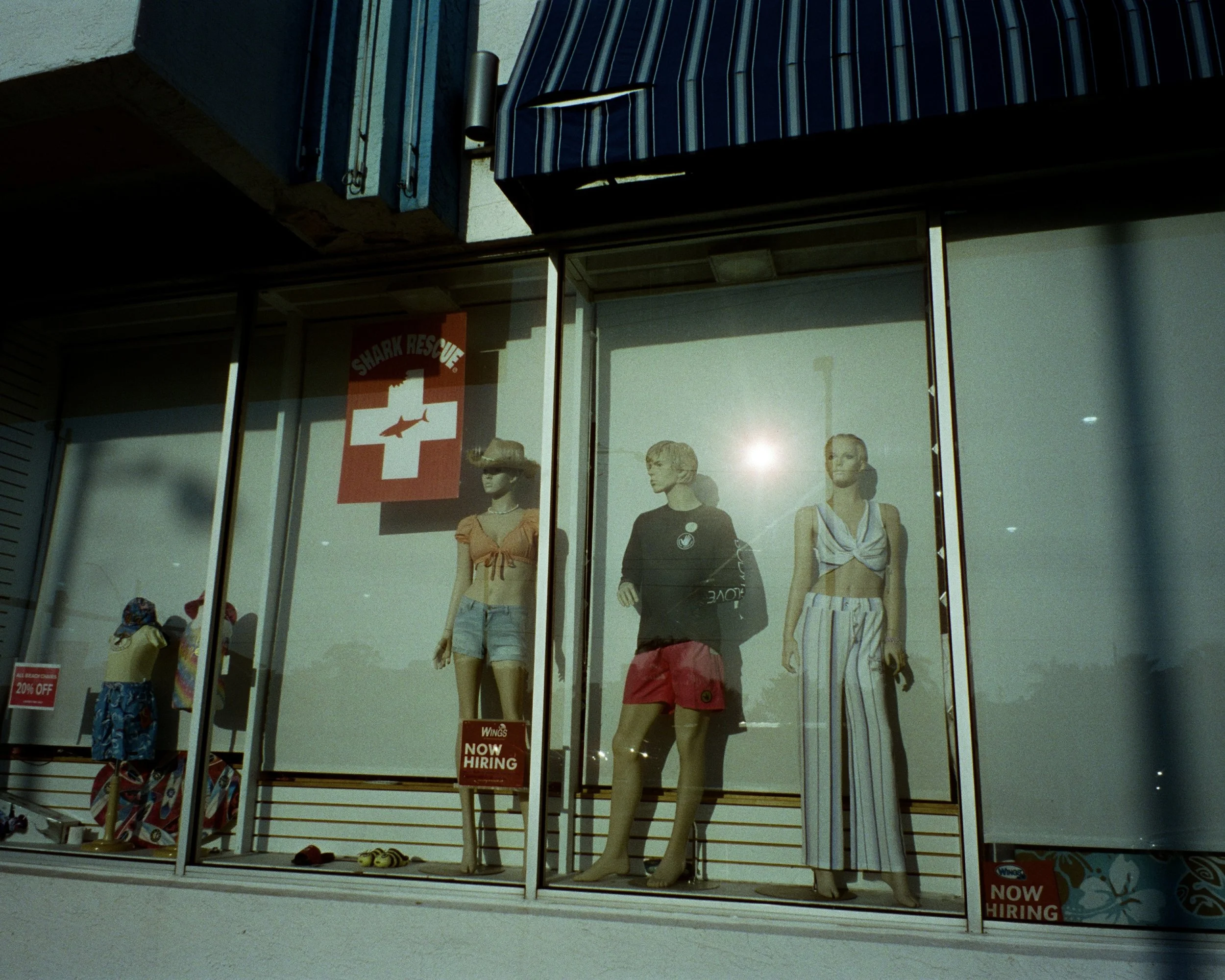 Mannequins in the window of a surf shop