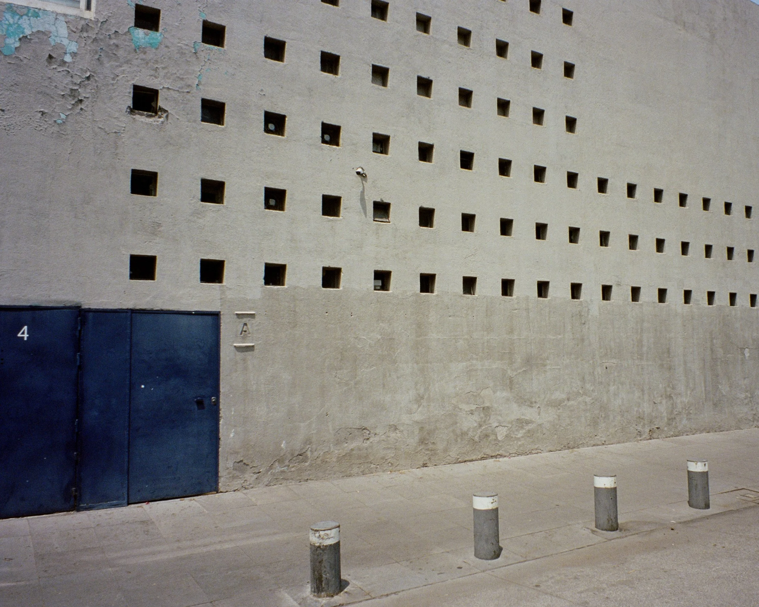 Small square windows on the concrete facade of Casa Barragan