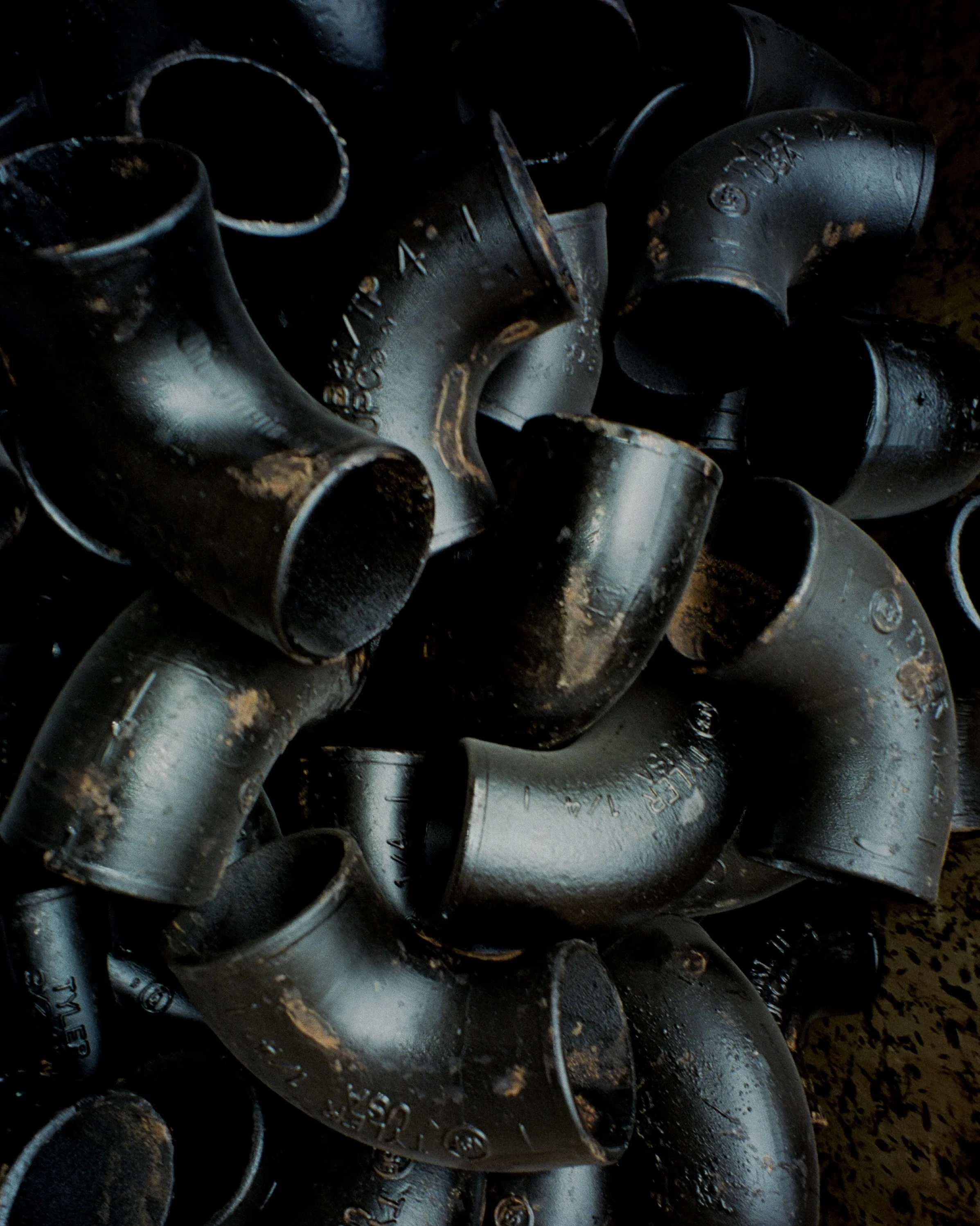 A close up of a tub full of black pipes
