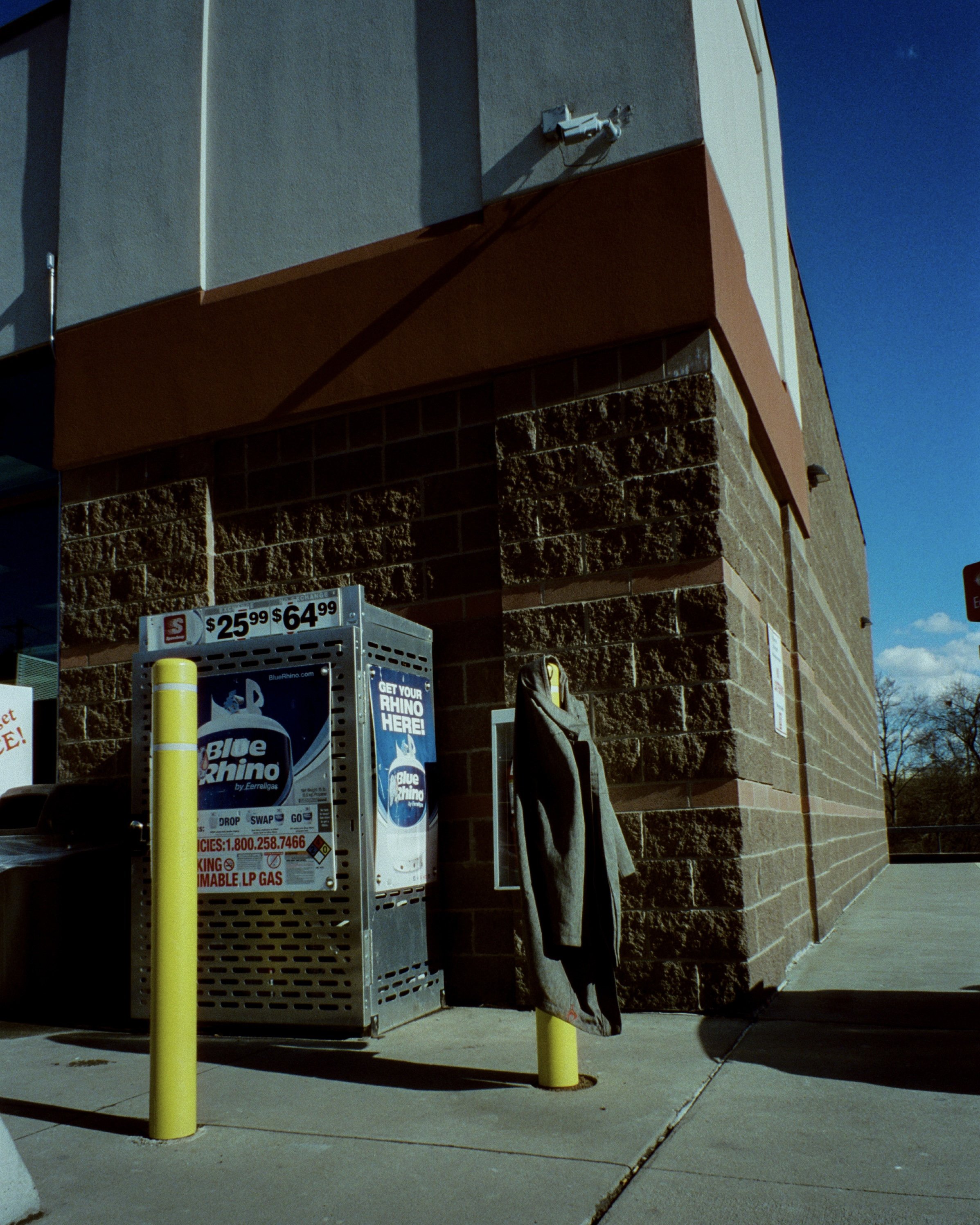 A coat draped over a safety pole