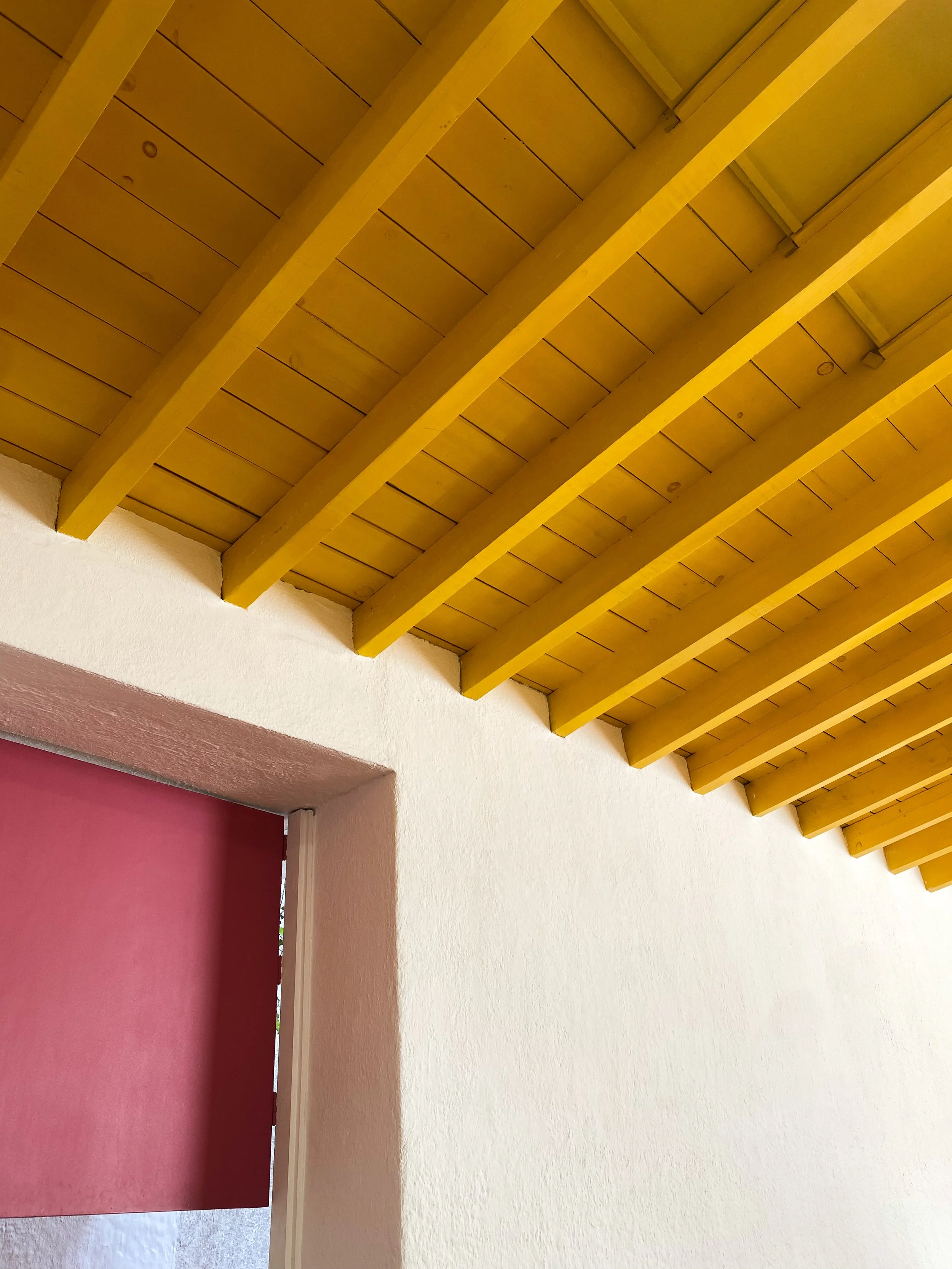 Yellow ceiling and pink door at Casa Barragan