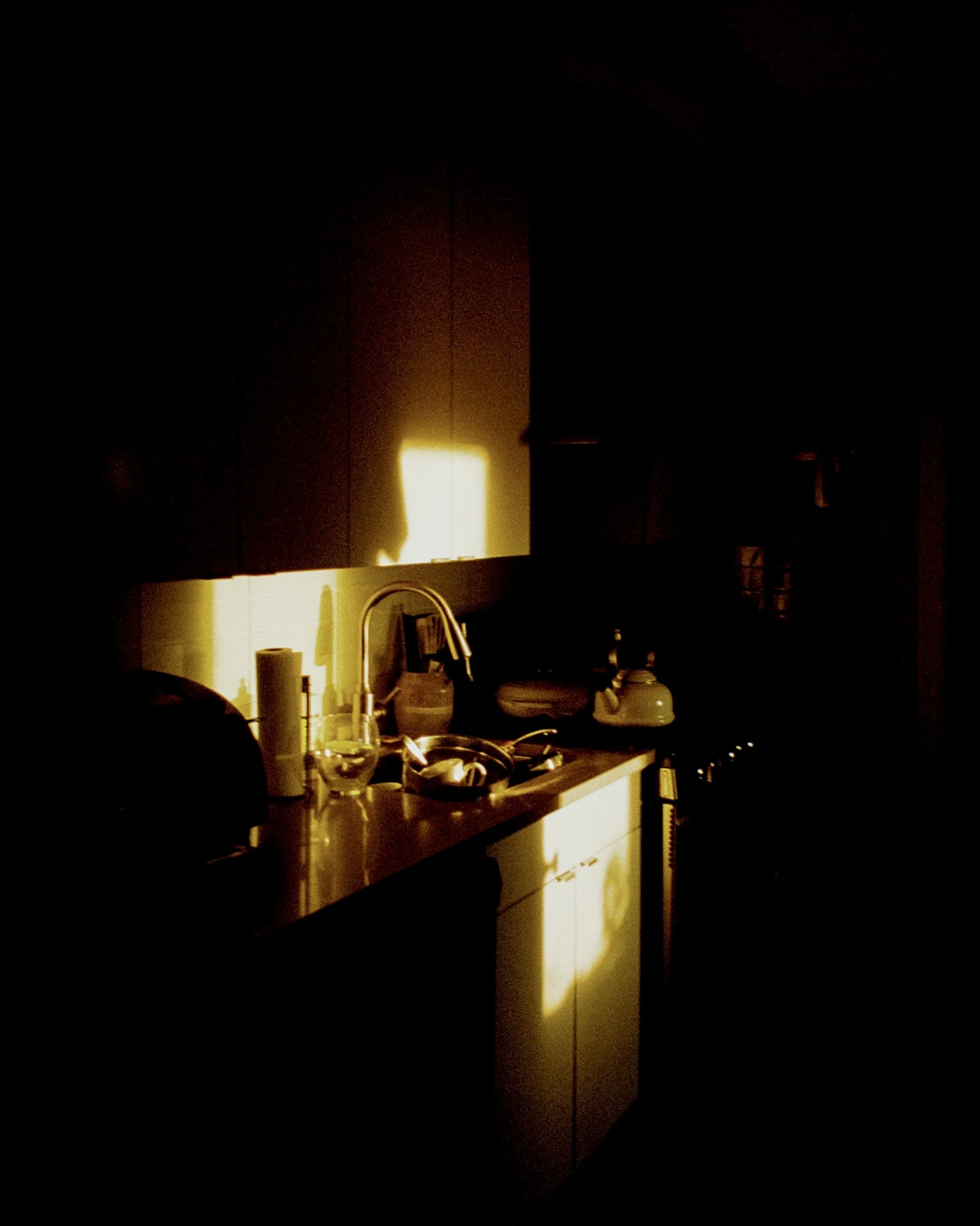 Golden hour sunlight shining on a kitchen sink