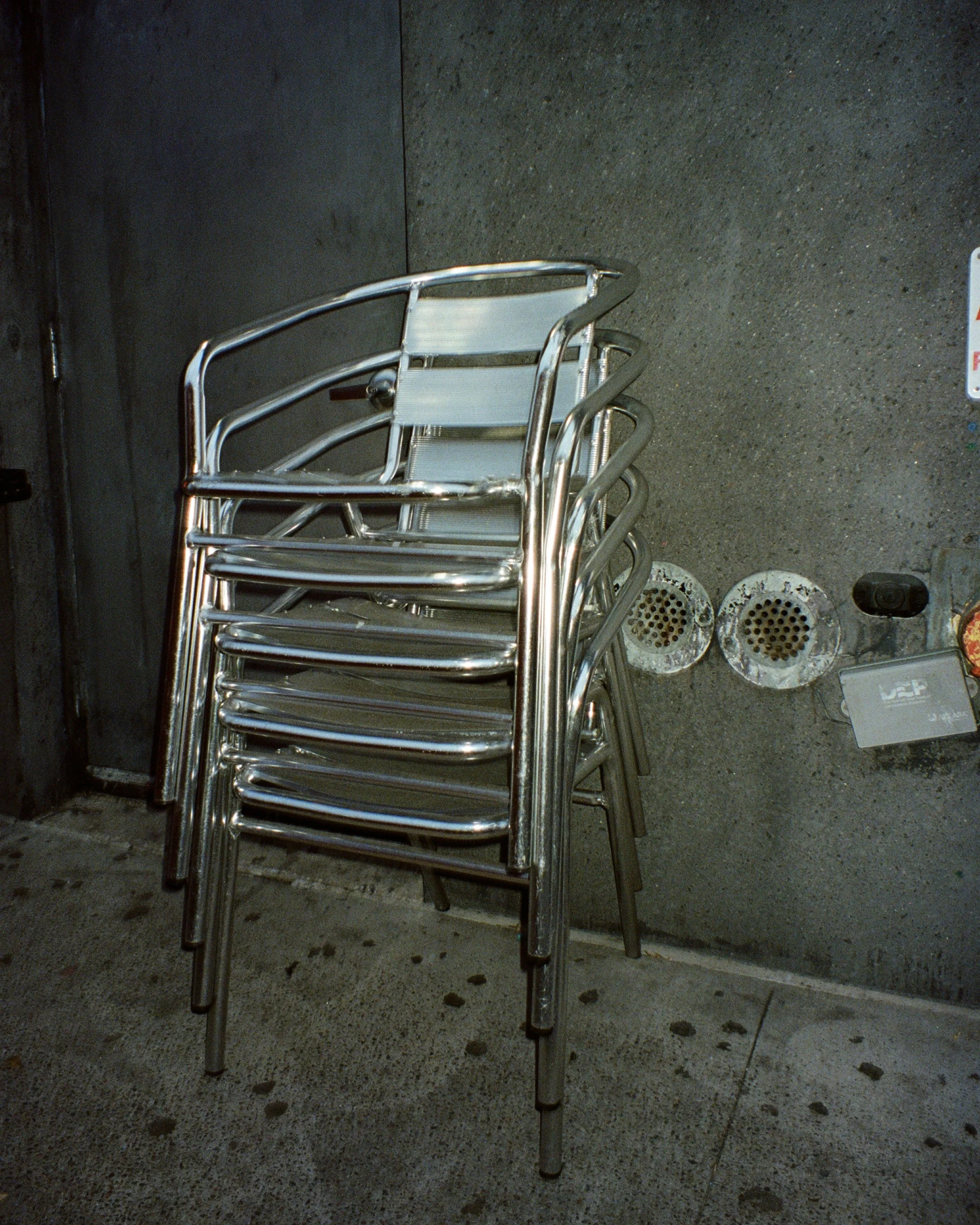 A stack of metal chairs on the street