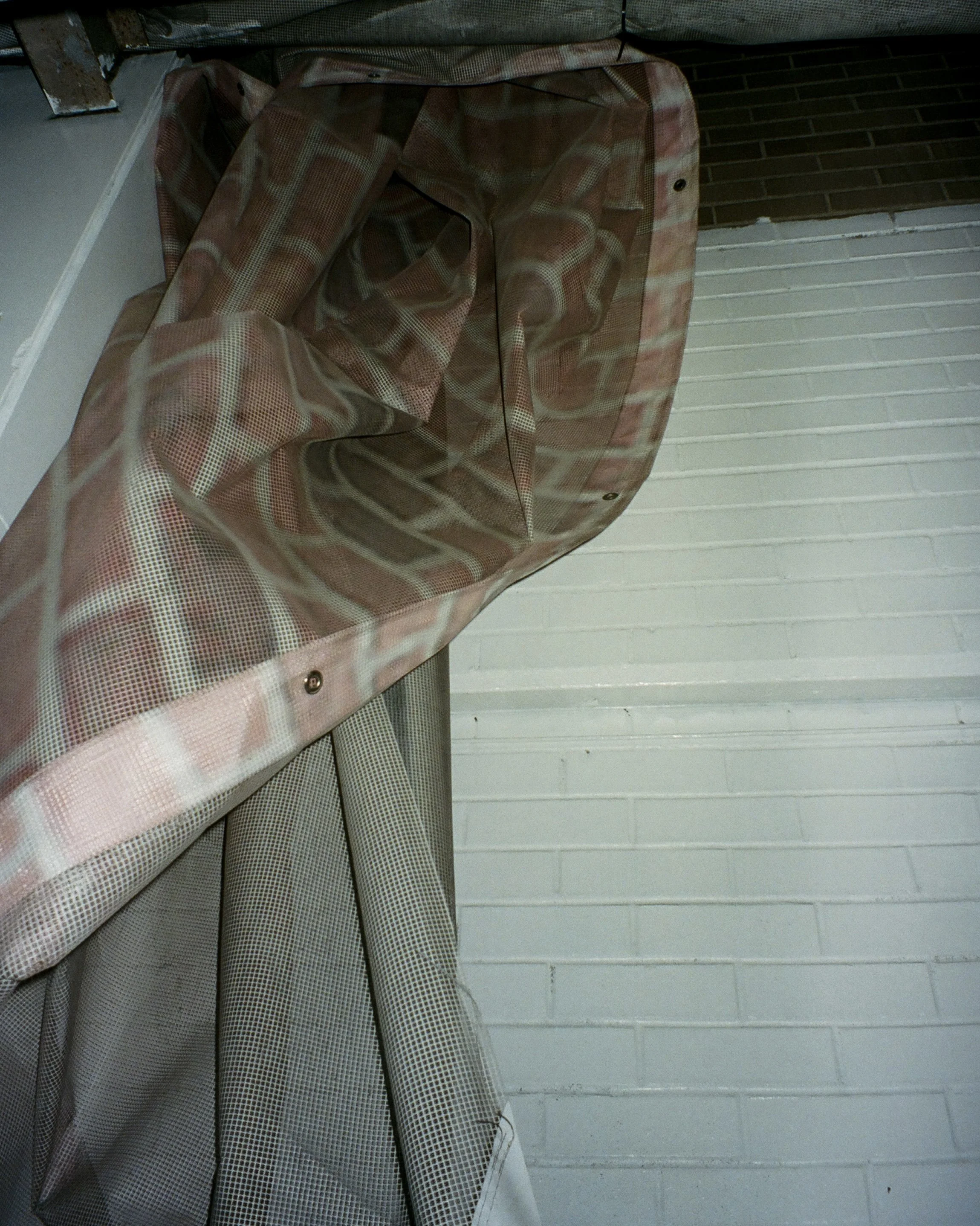 Brick print tarp on the side of a building