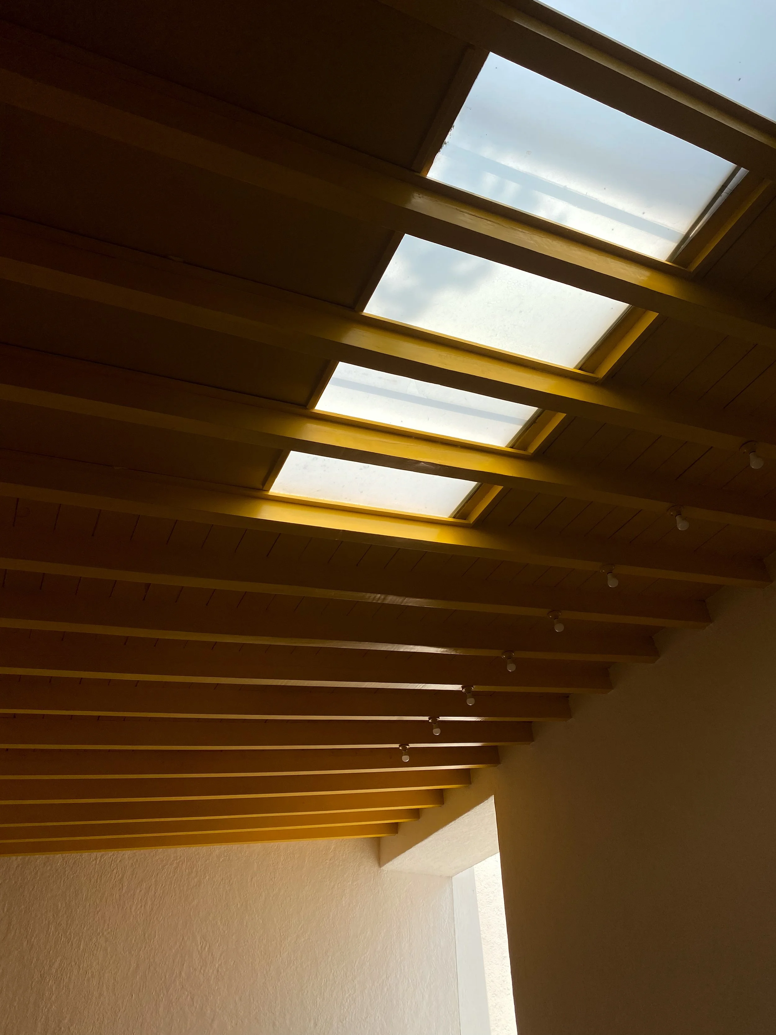 Four skylights in a yellow ceiling at Casa Barragan