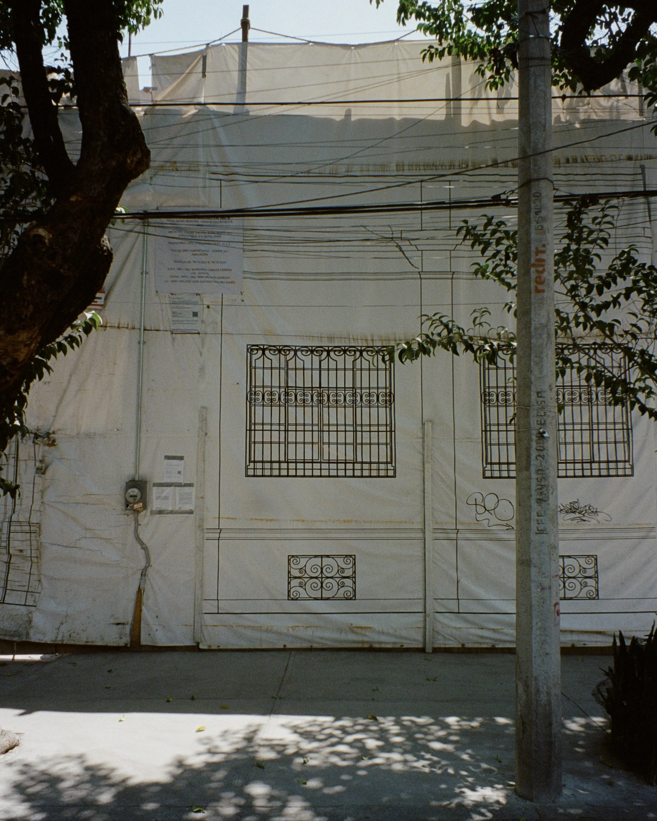 A tarp with a print of a building on it covering a building