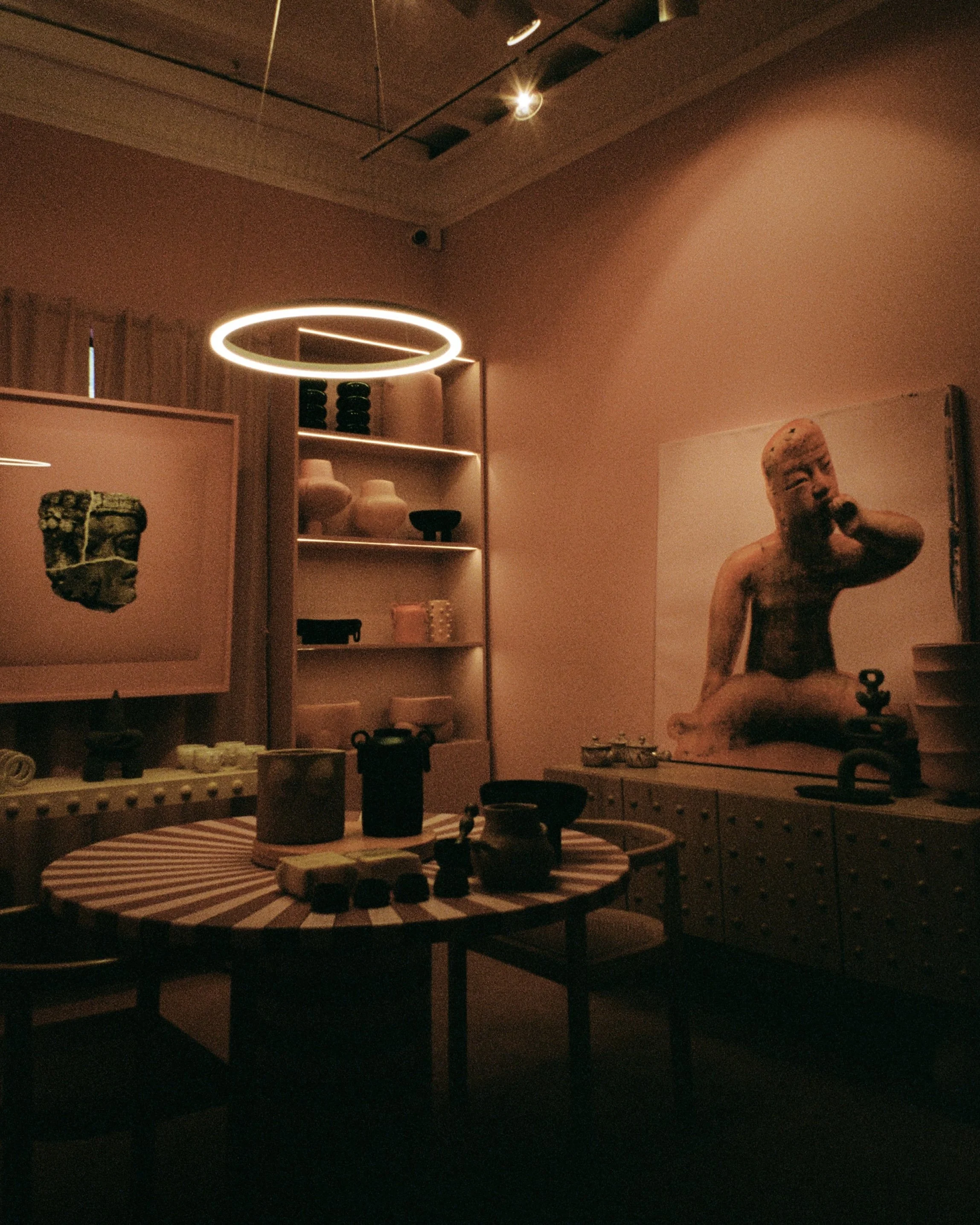 A pink room with pink objects and artwork