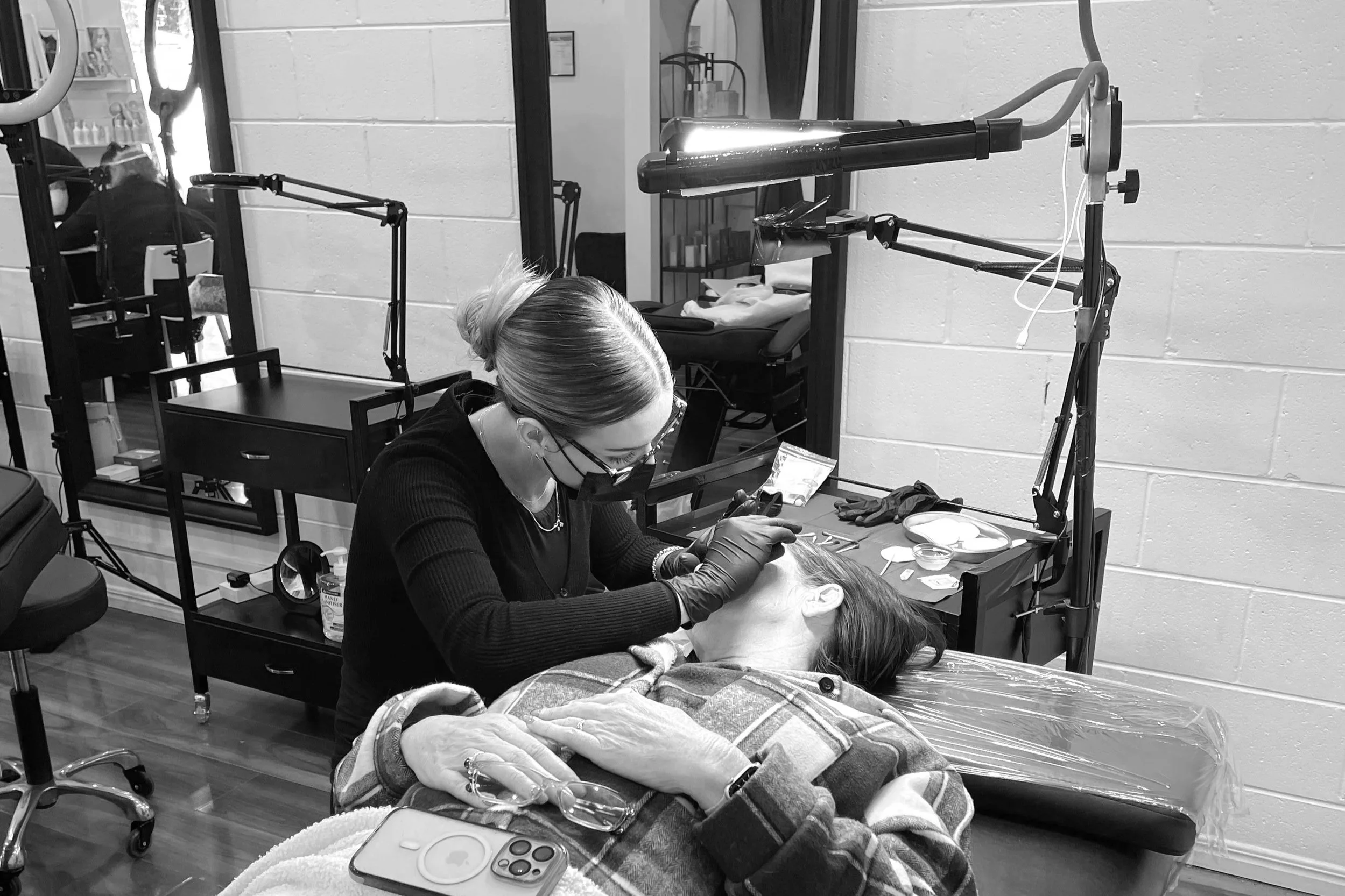 lady laying on a clinic bed getting cosmetic tattooing done