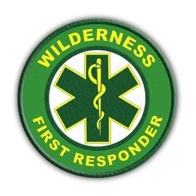 Wilderness First Responder emergency medical service badge with green and yellow colors.