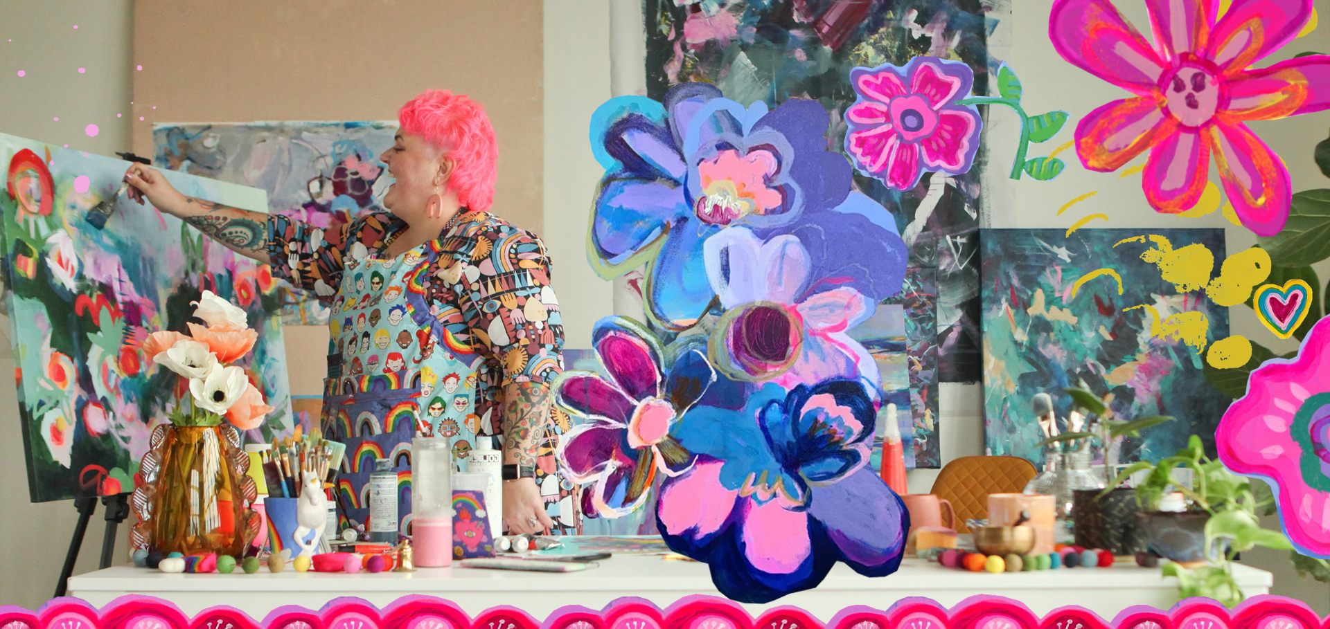 A woman with pink hair and tattoos on her arm is painting at an art studio filled with colorful abstract floral paintings and vibrant artworks. The scene includes art supplies, flowers in a vase, and whimsical doodles on the images.