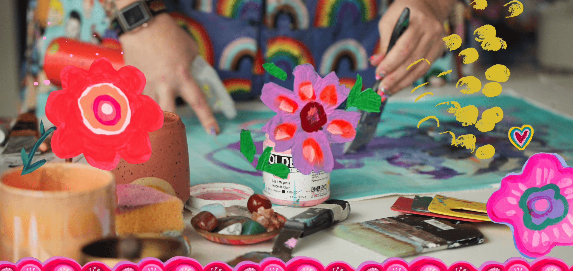 A person creating colorful flower paintings with brushes, surrounded by art supplies, paper, and decorated with digital doodles of flowers, hearts, and yellow paint splashes.
