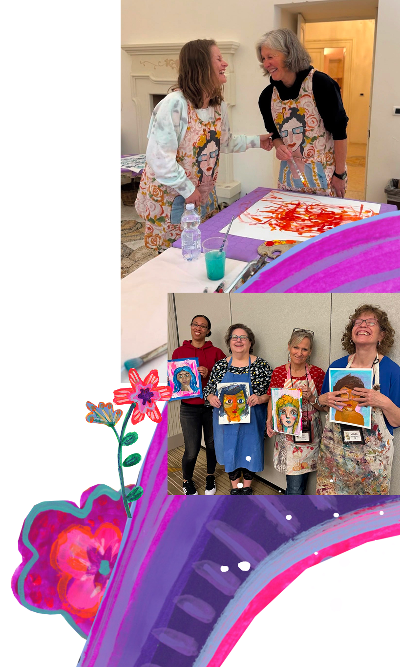 Two women in aprons painting on a canvas, smiling and laughing, with a group of women holding finished portraits of themselves, showing vibrant, colorful abstract portrait art.